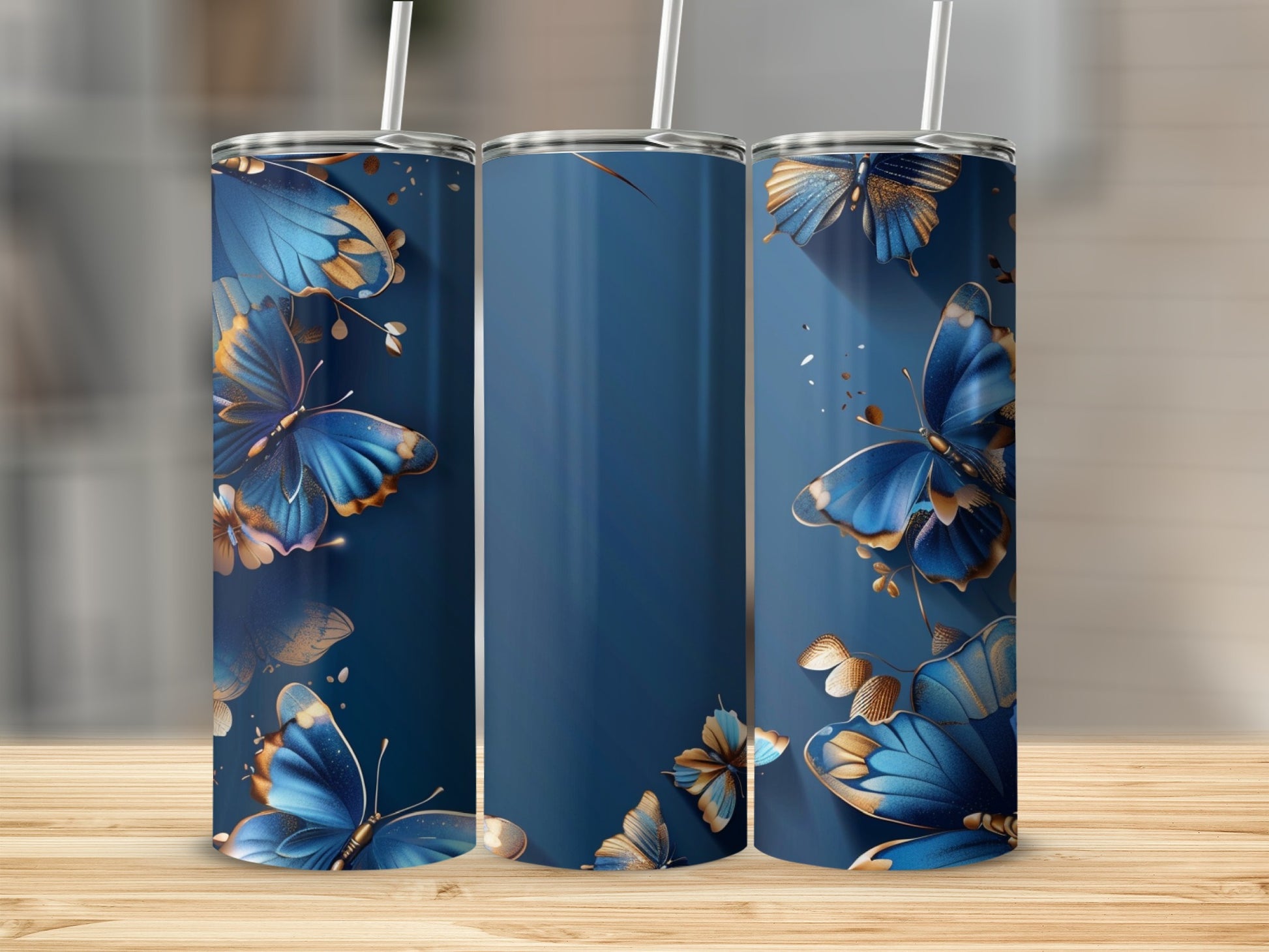 Three navy blue tumblers with gold and blue butterfly designs.
