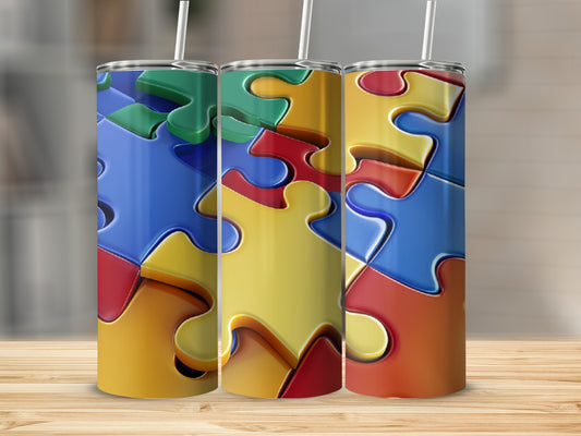 Three tumblers with colorful interlocking puzzle pieces, standing on a wooden surface.