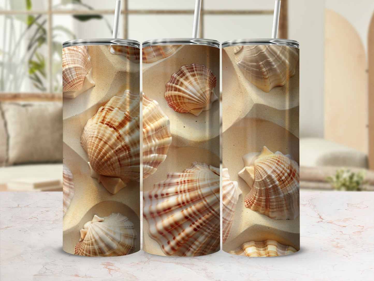 Three tumblers with a sandy beach and seashell pattern.