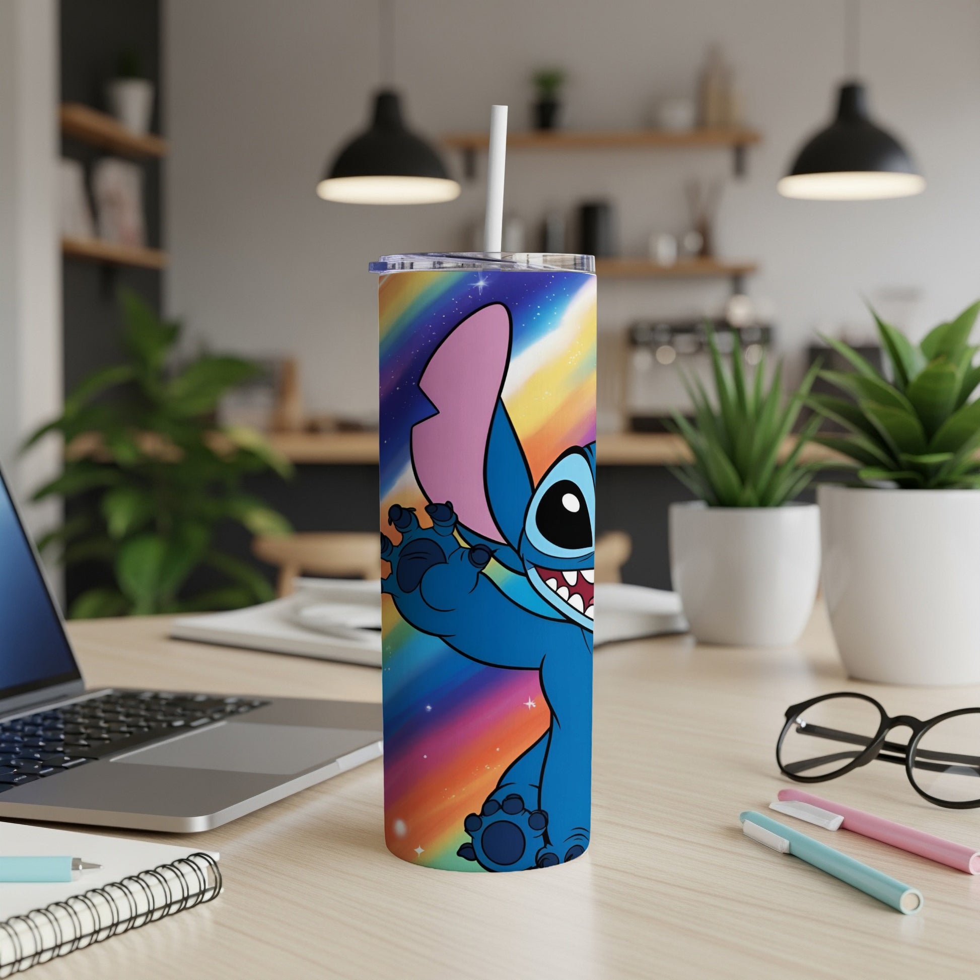Stitch character on a rainbow gradient tumbler with a straw, on a desk.