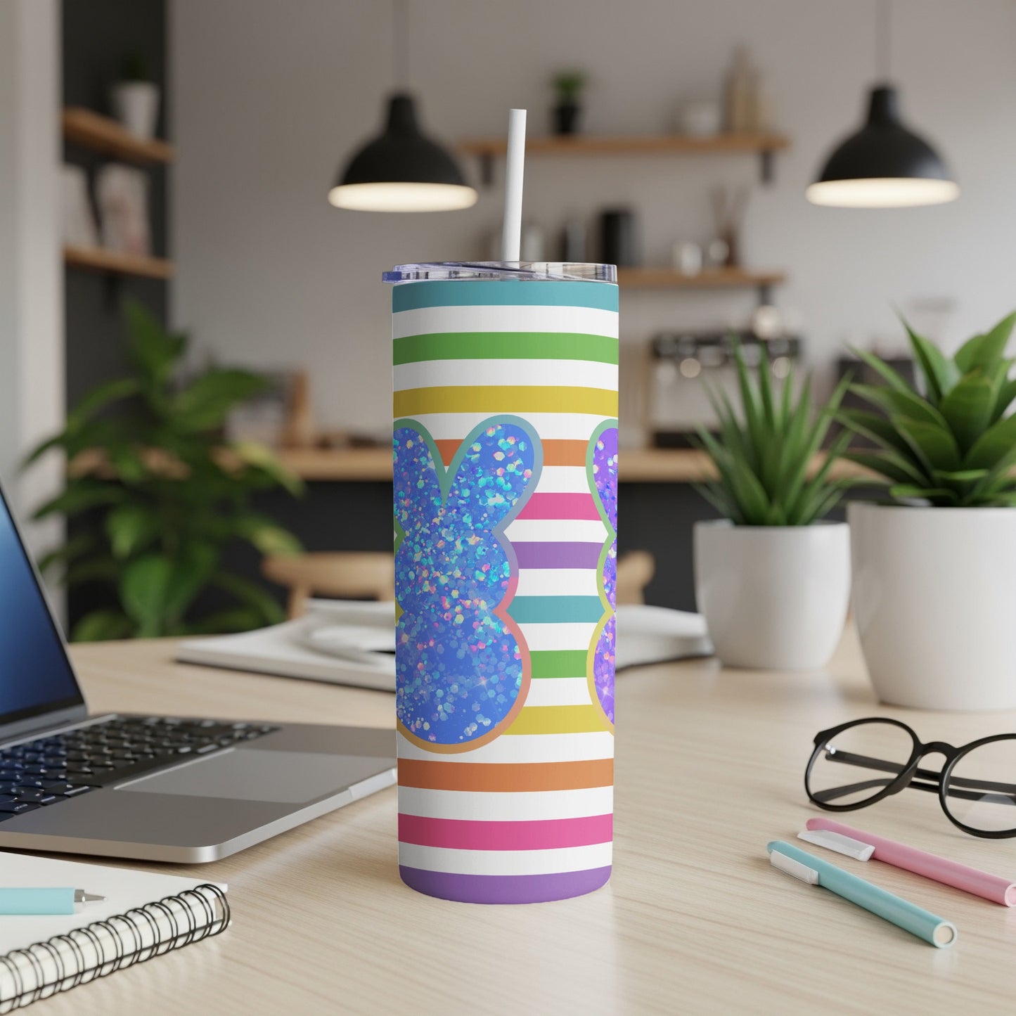 Striped tumbler with glittery blue bunny graphic and straw.