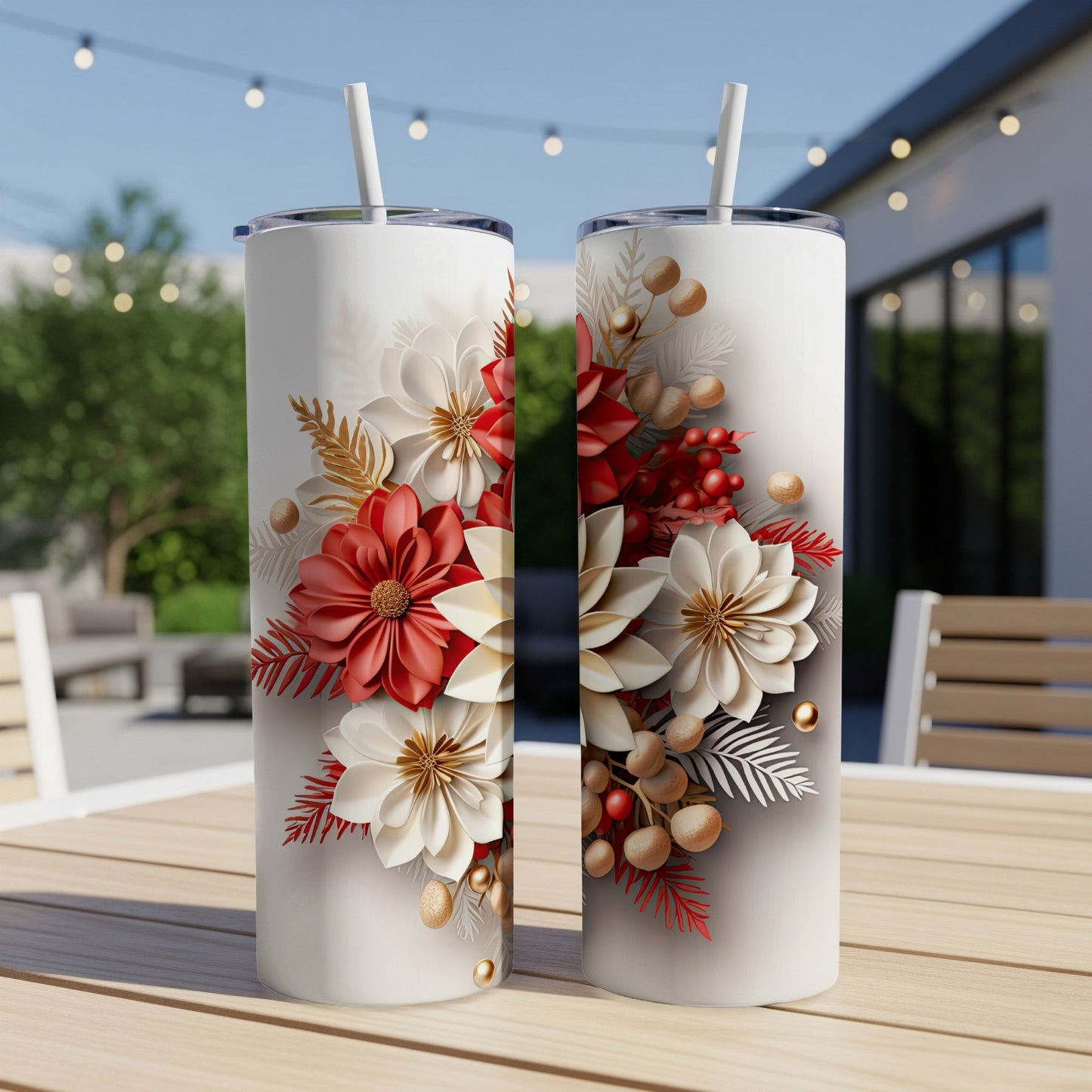 Two tall white tumblers with red and white floral designs sit on a wooden table.
