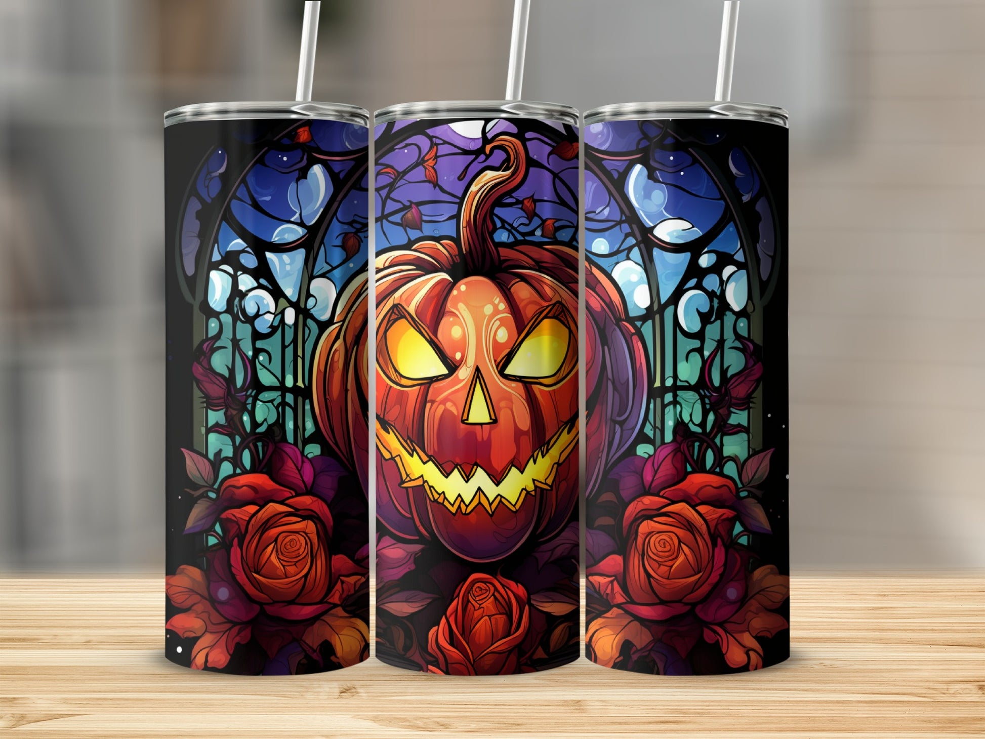 Three tumblers featuring a jack-o'-lantern and roses with a stained-glass background.