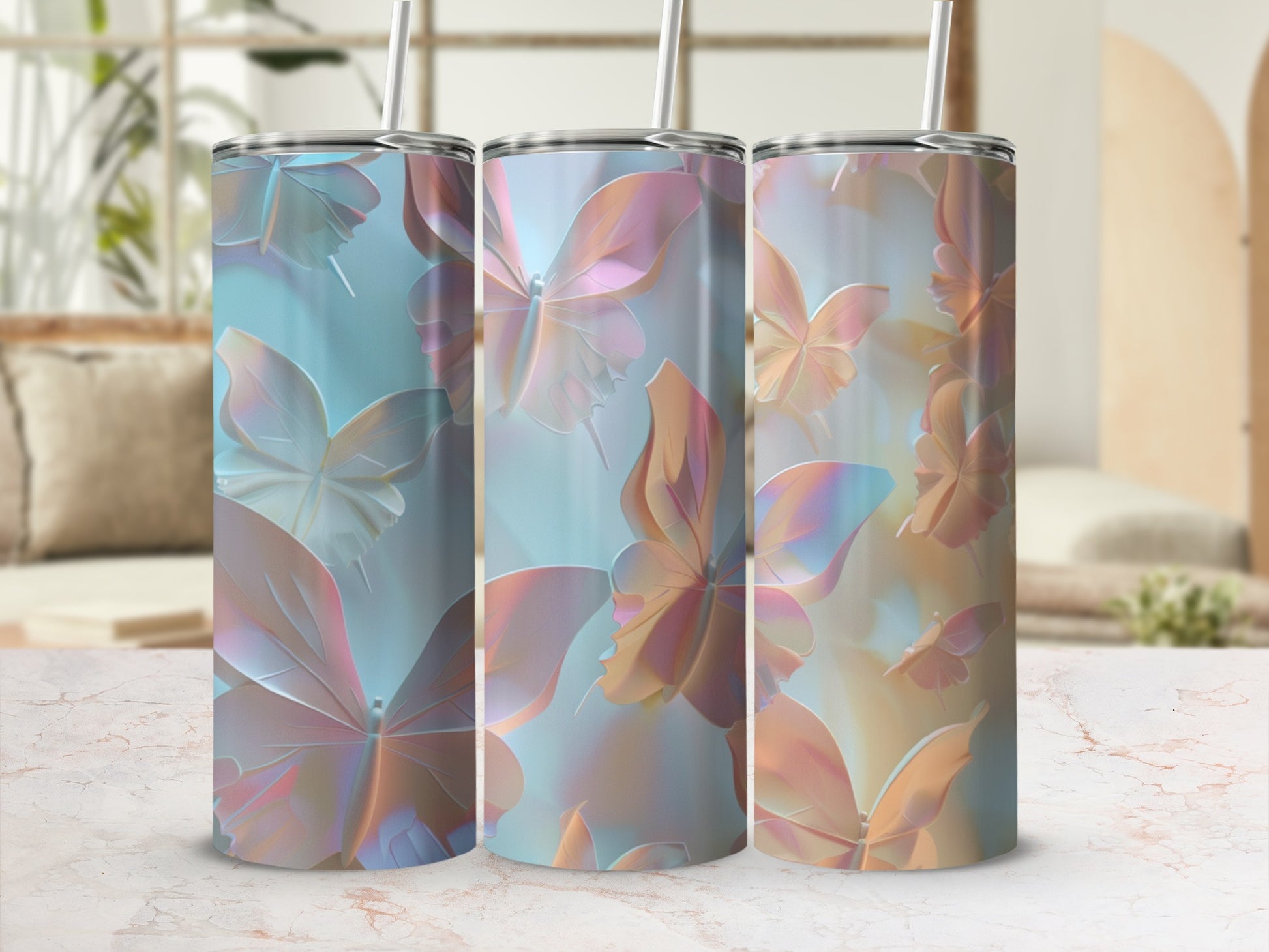 Three tumblers with iridescent butterfly designs on a light-colored surface.