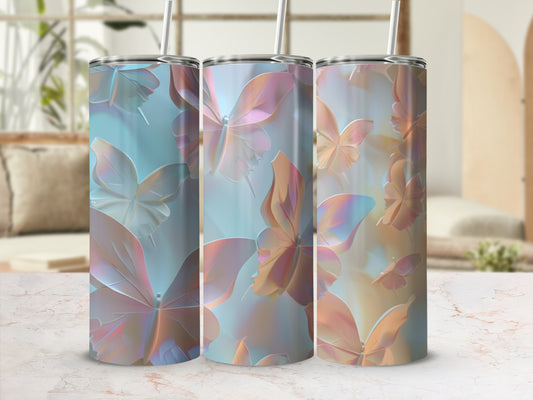 Three tumblers with iridescent butterfly designs on a light-colored surface.