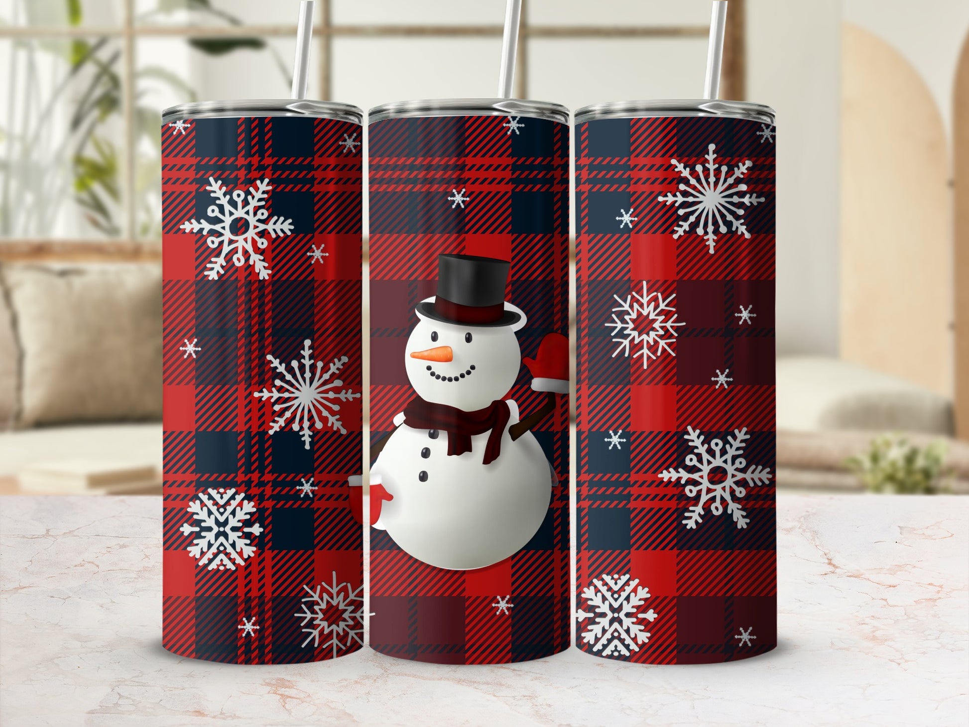 Tumbling snowman on a red and blue plaid tumbler with snowflakes.