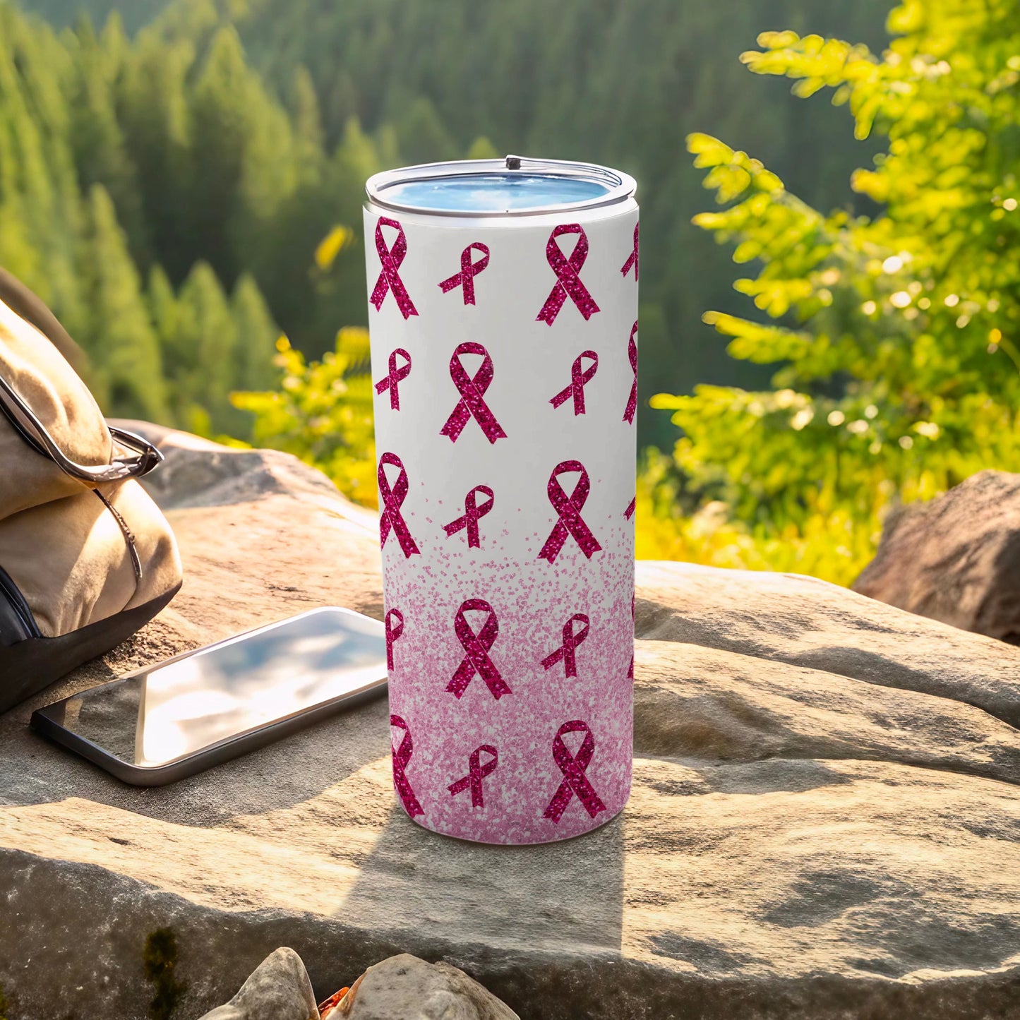 Pink breast cancer awareness ribbons cover a stainless steel tumbler.
