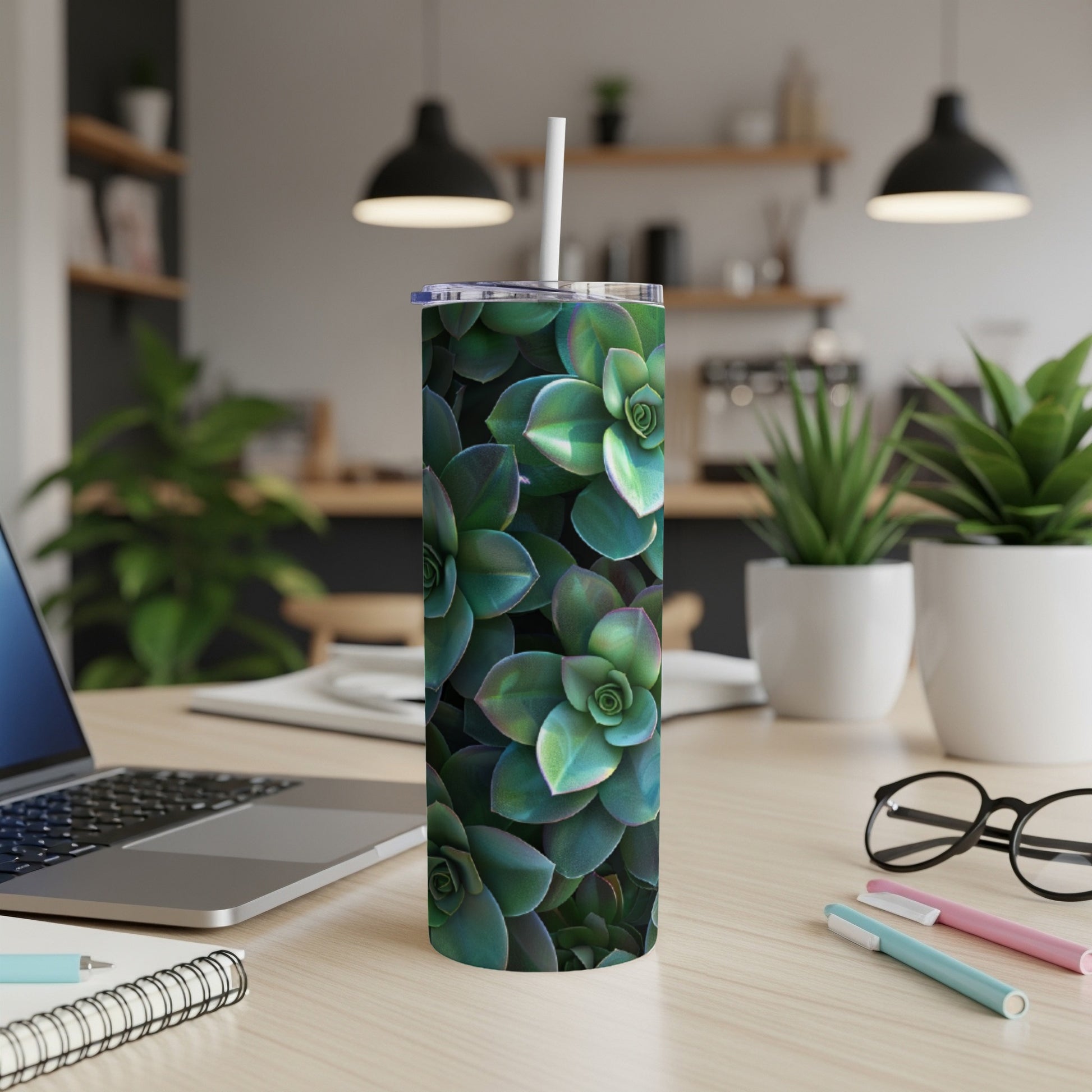 Green succulent plant pattern on a white tumbler with a straw.