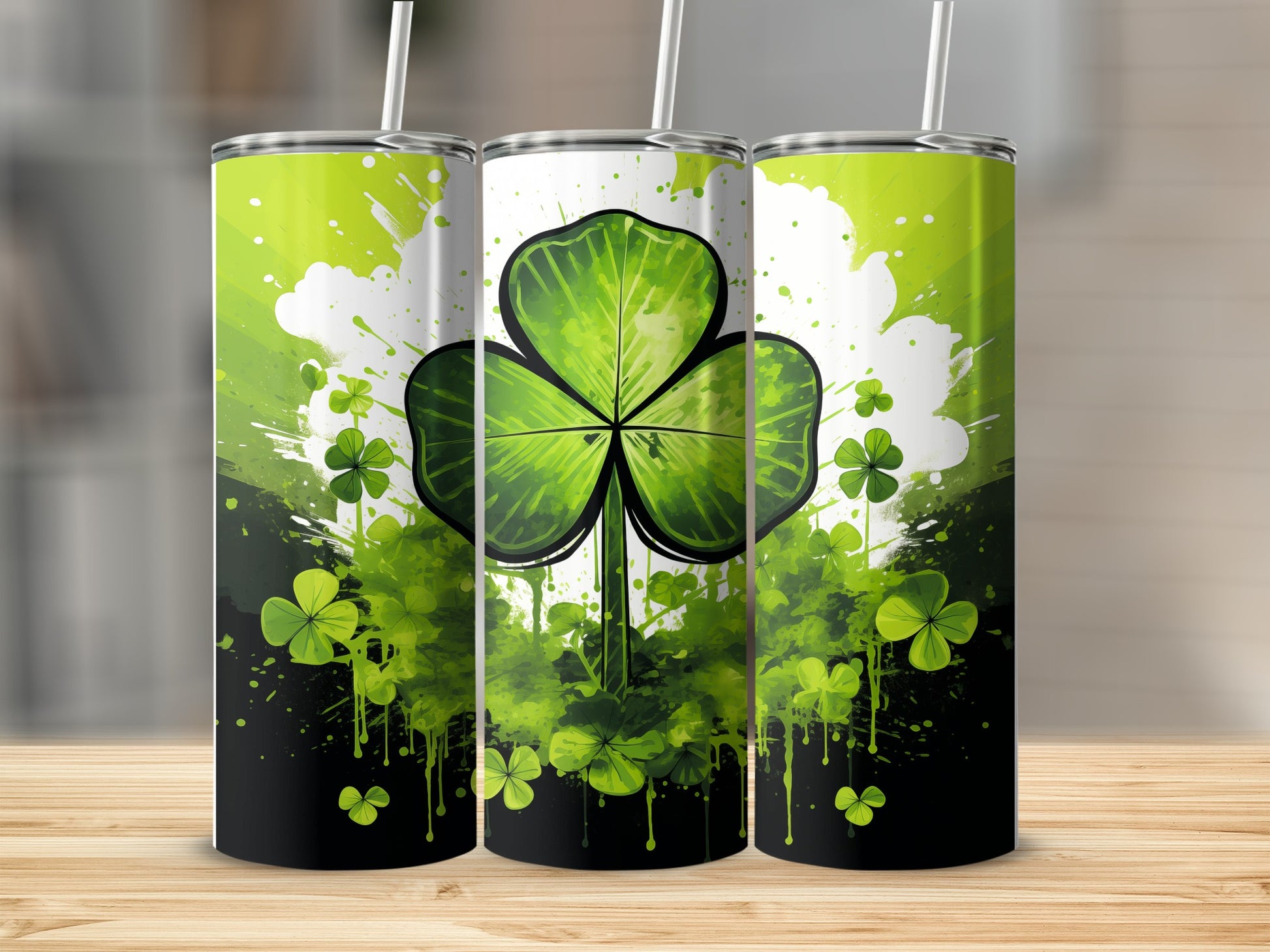 Three shamrock tumblers with green splatters and green shamrocks.