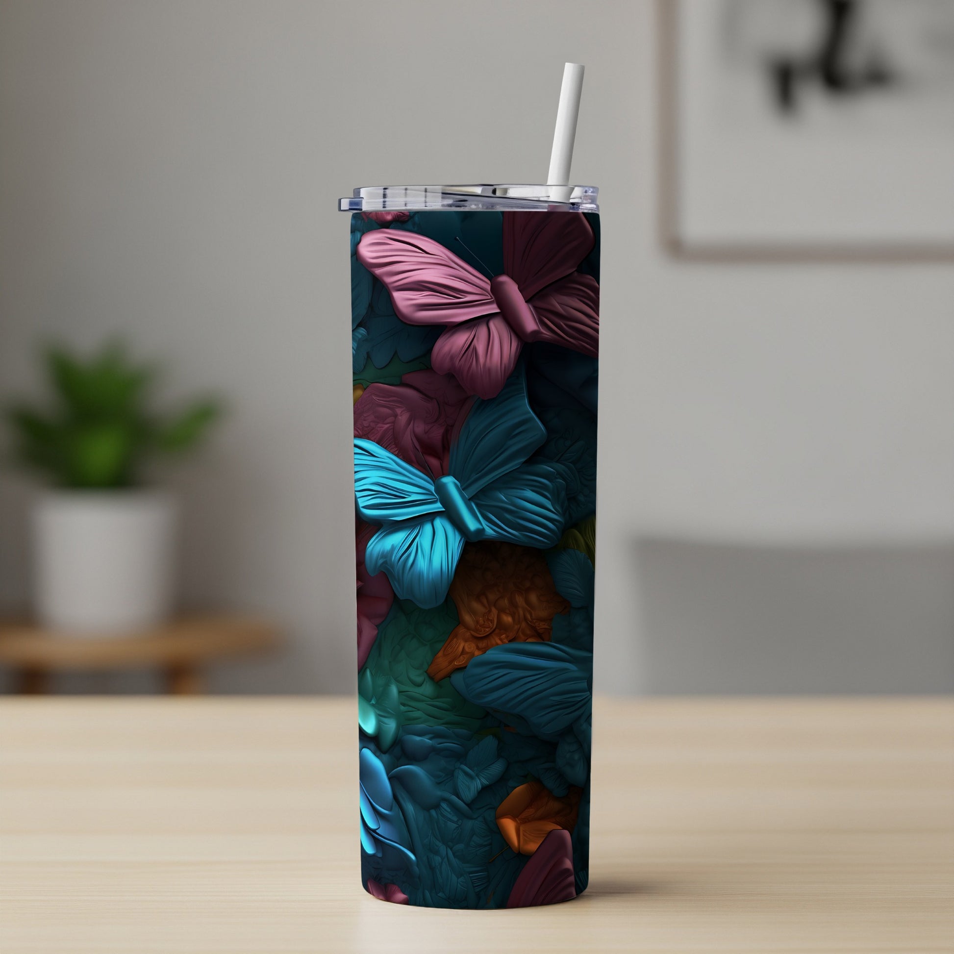 Tall tumbler with colorful butterfly pattern and straw.