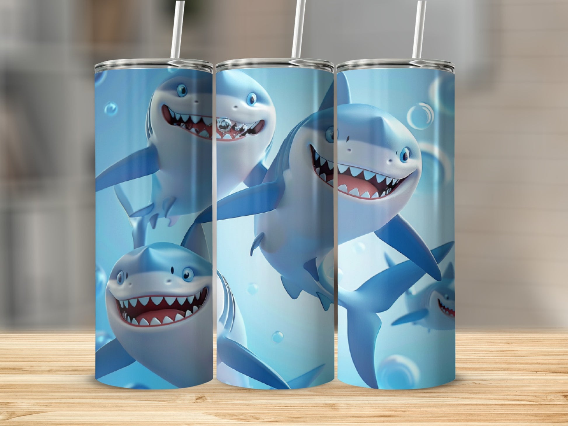 Tumblers with cartoon sharks and bubbles on a wooden surface.