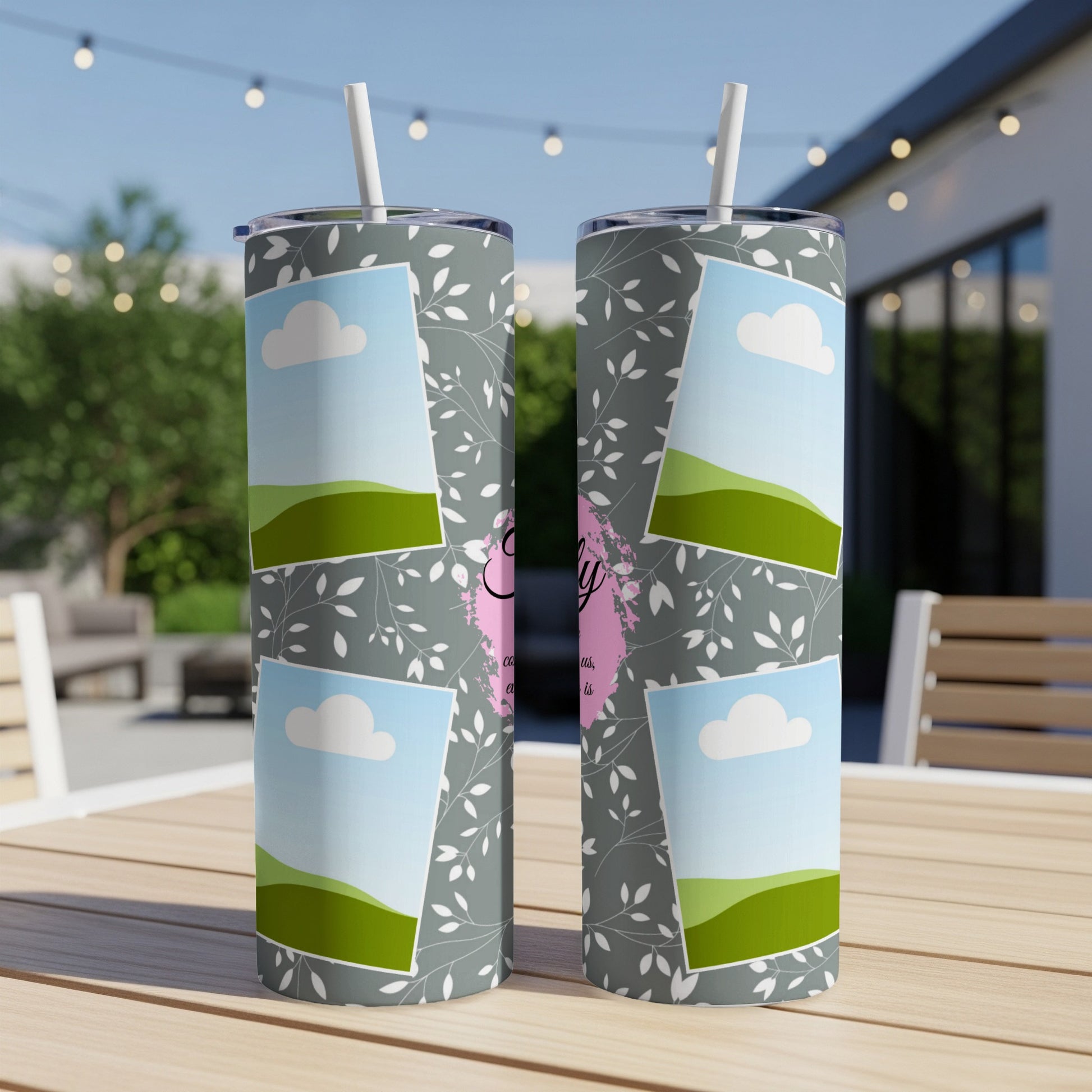 Two tumblers with floral pattern, clouds, and green hills with text.