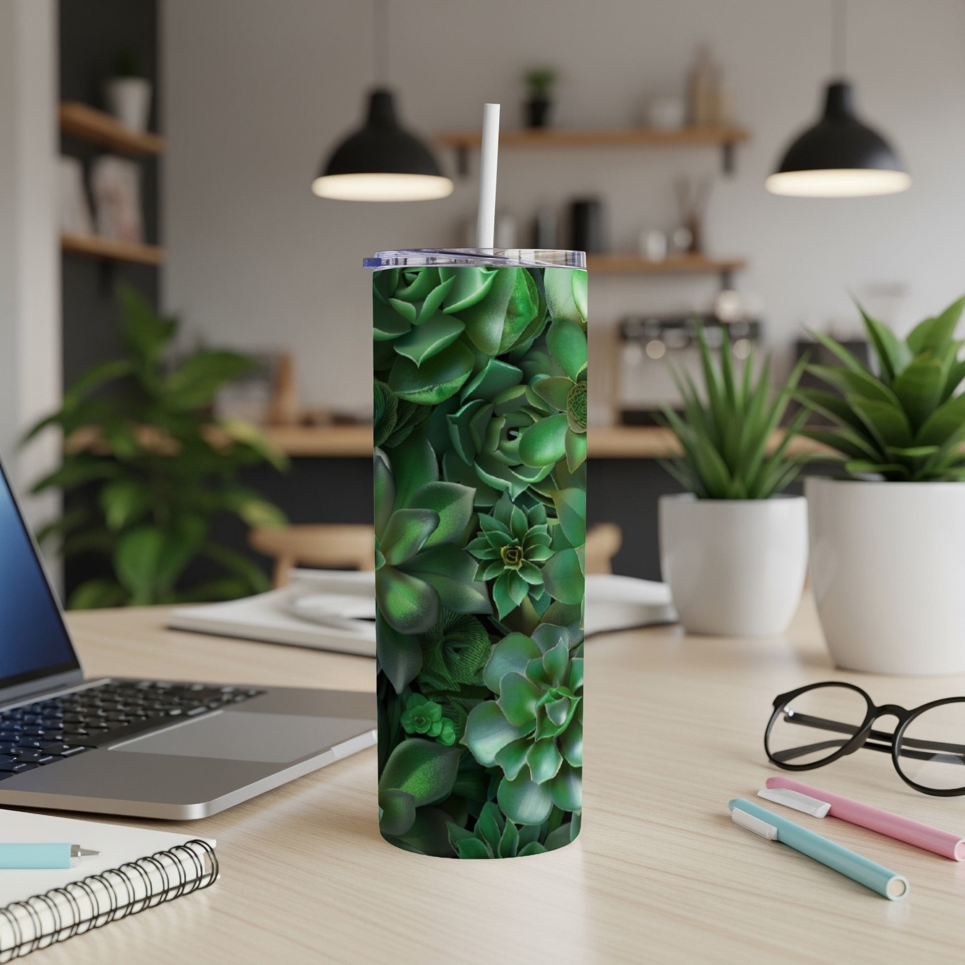 Green succulent plants cover a white tumbler on a desk.