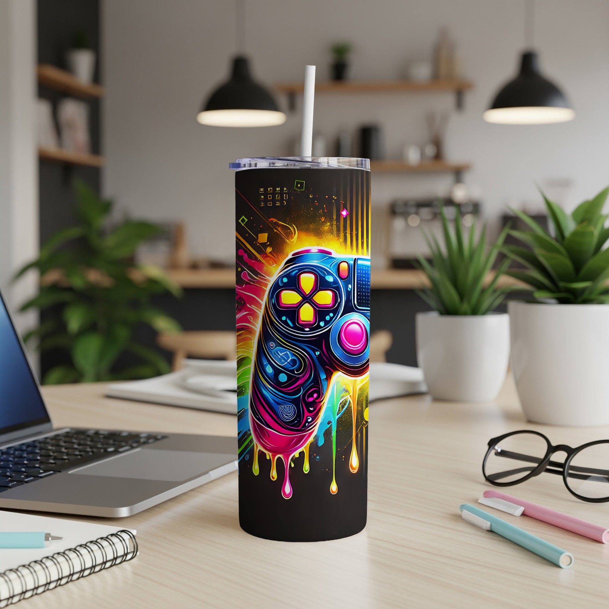 Colorful video game controller design on a black tumbler with a white straw.