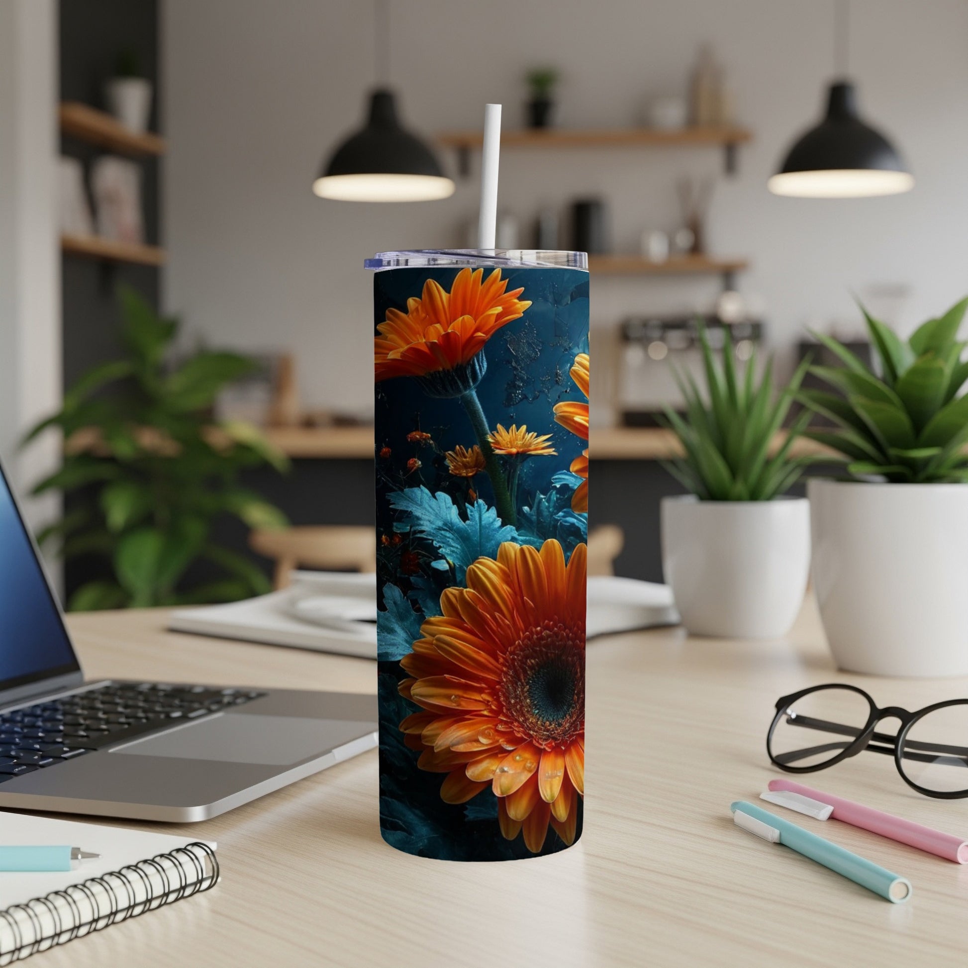 Orange and blue gerbera daisies pattern on a tall, white tumbler.