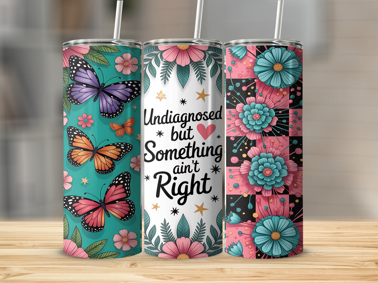 Three tumblers with butterfly, floral, and text "Undiagnosed but Something ain't Right" designs.