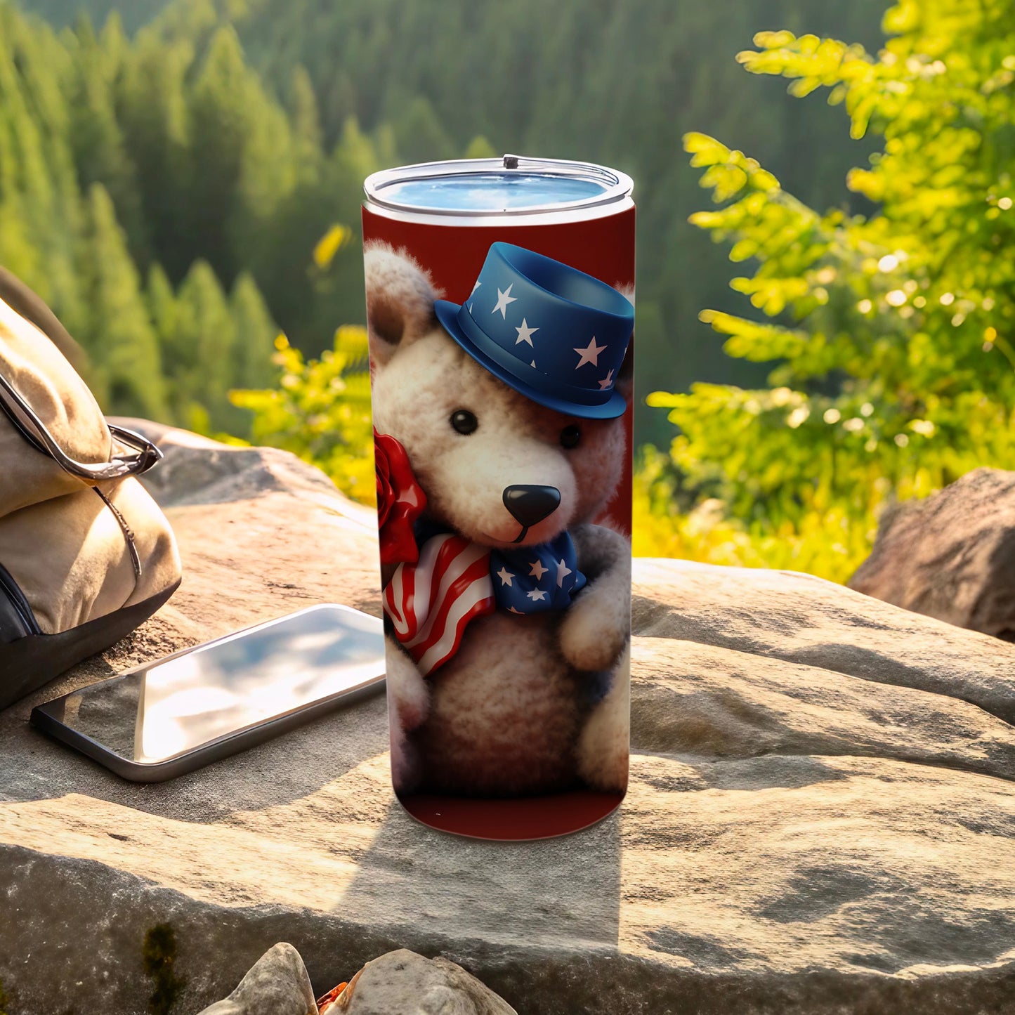 Teddy bear in patriotic hat and scarf on a tumbler outdoors.