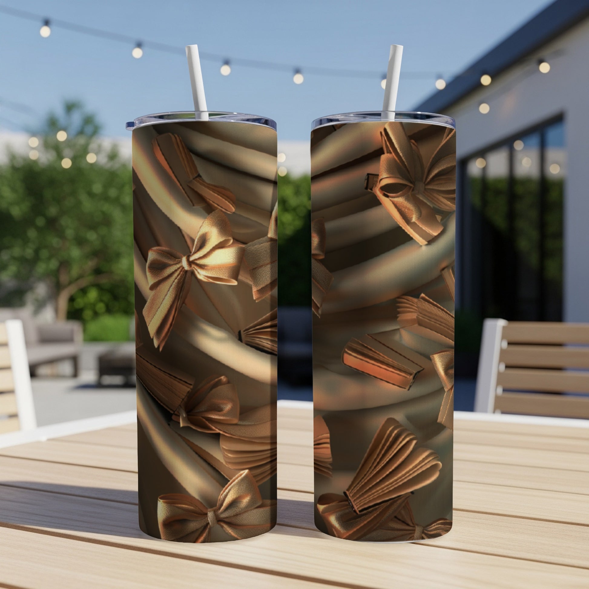 Two bronze tumblers with a satin bow pattern on a table.