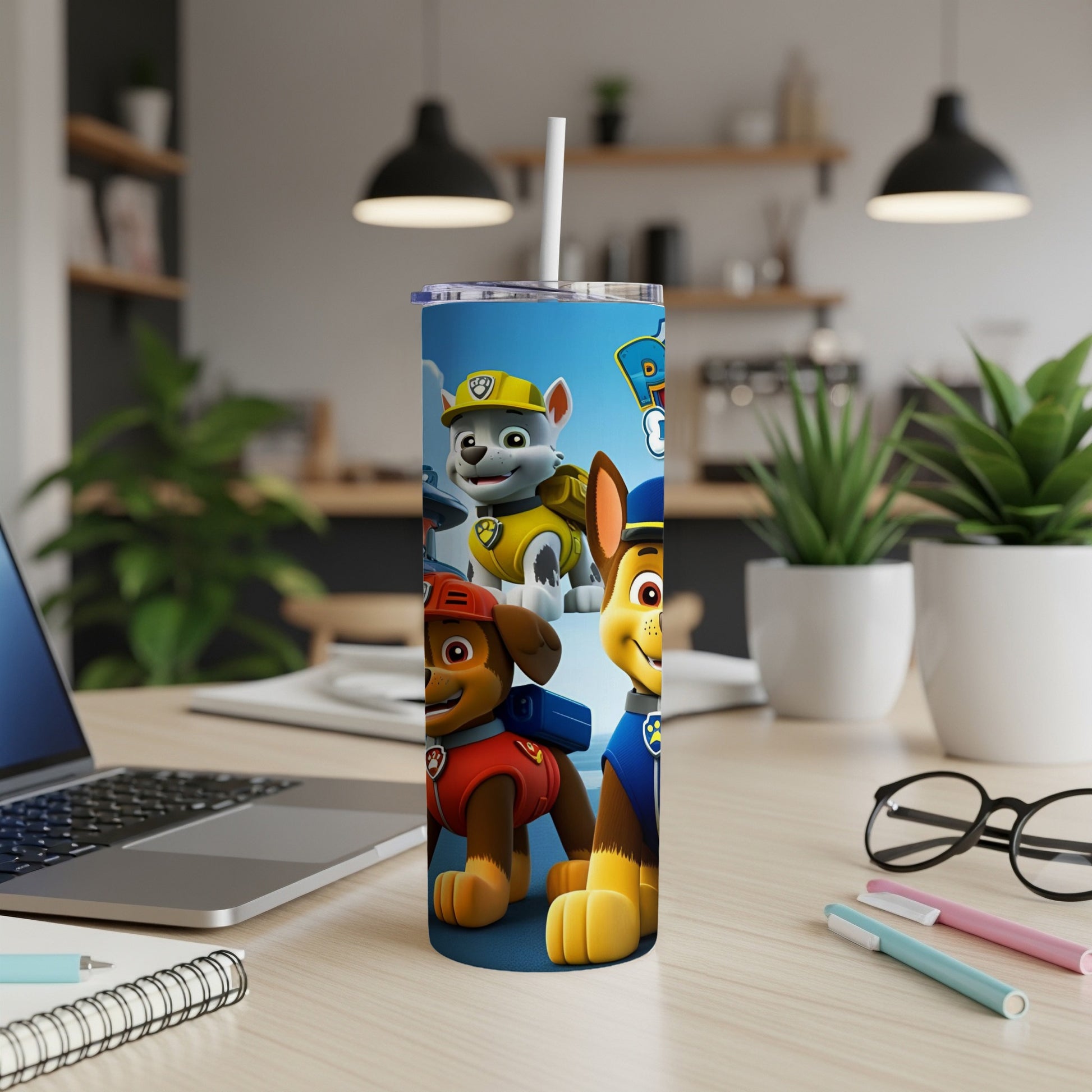 Paw Patrol characters Ryder, Chase, and Marshall on a blue tumbler with a white straw.