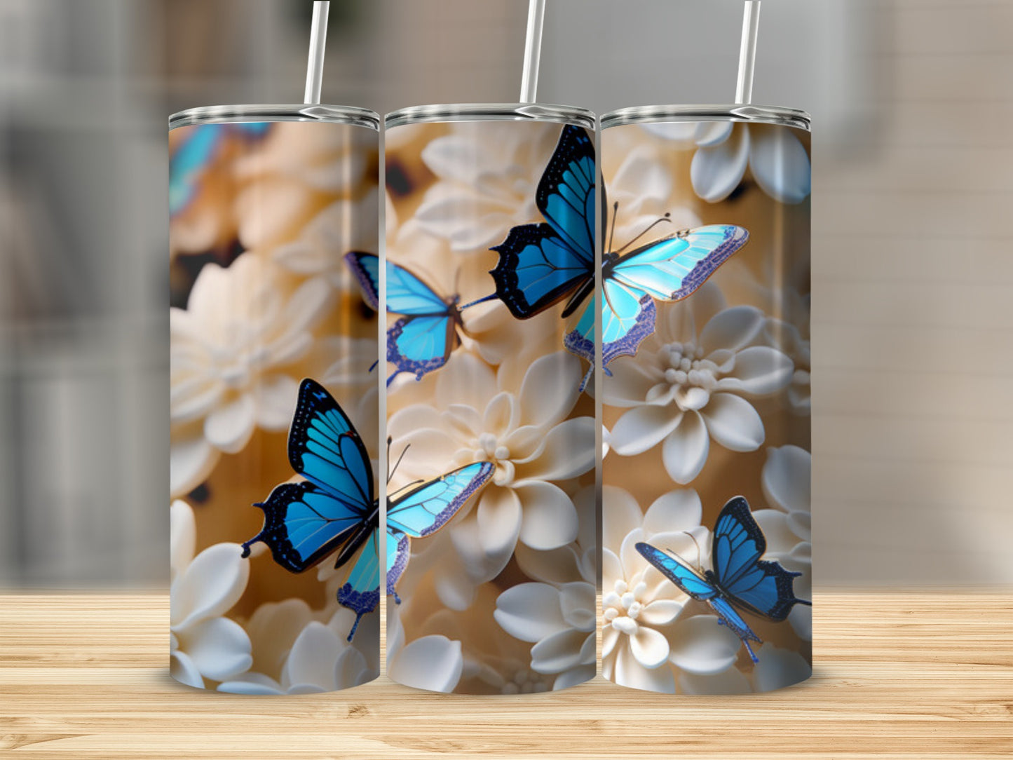 Three tumblers with blue butterflies and white flowers.