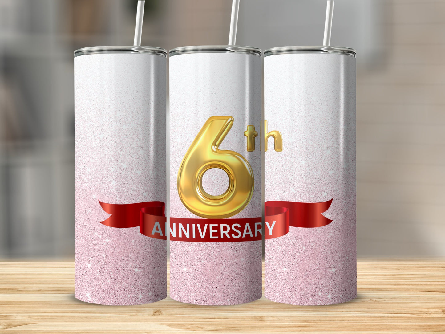 Three 6th anniversary tumblers with red ribbon and glittery background.