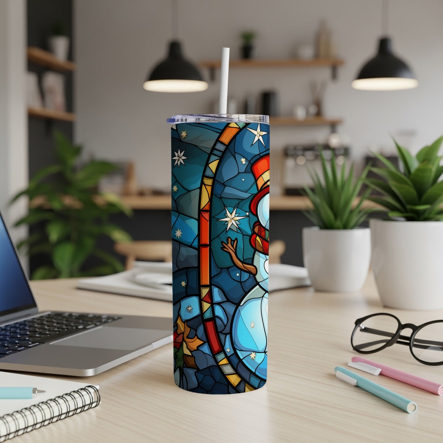 Stained glass snowman design on a white skinny tumbler with straw.