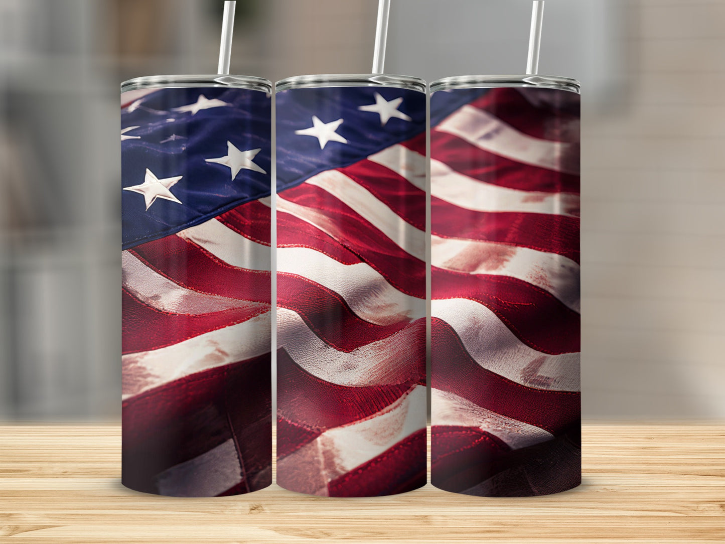 Three tumblers featuring an American flag design, standing on a wooden surface.