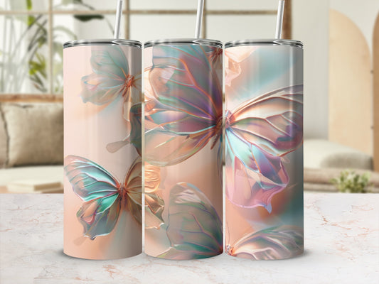 Three tumblers featuring iridescent butterfly wings on a marble surface.