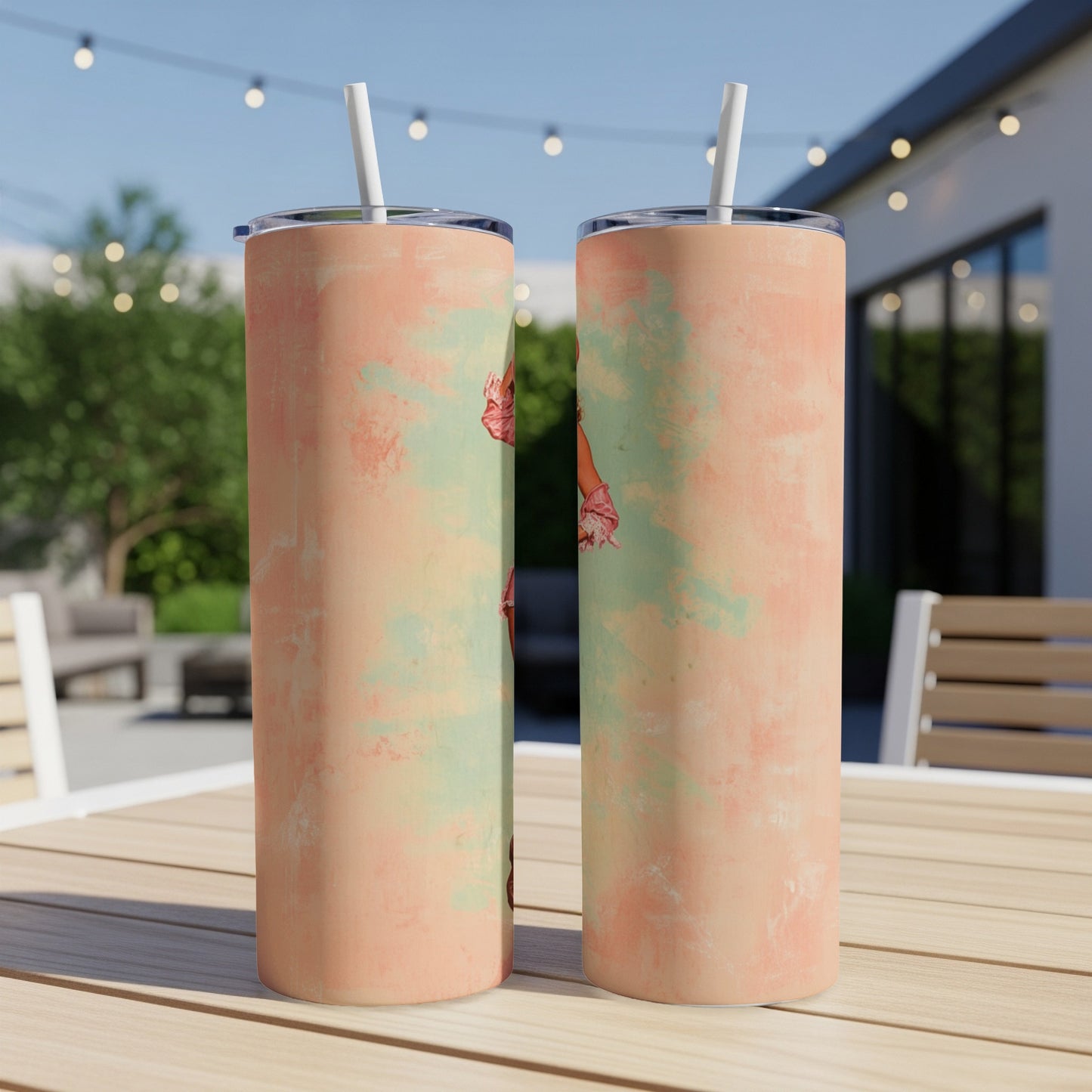 Two tall, skinny tumblers with a vintage floral pattern on a wooden table outdoors.