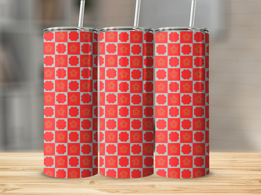 Three tumblers with a red and blue floral checkerboard pattern on a wooden surface.