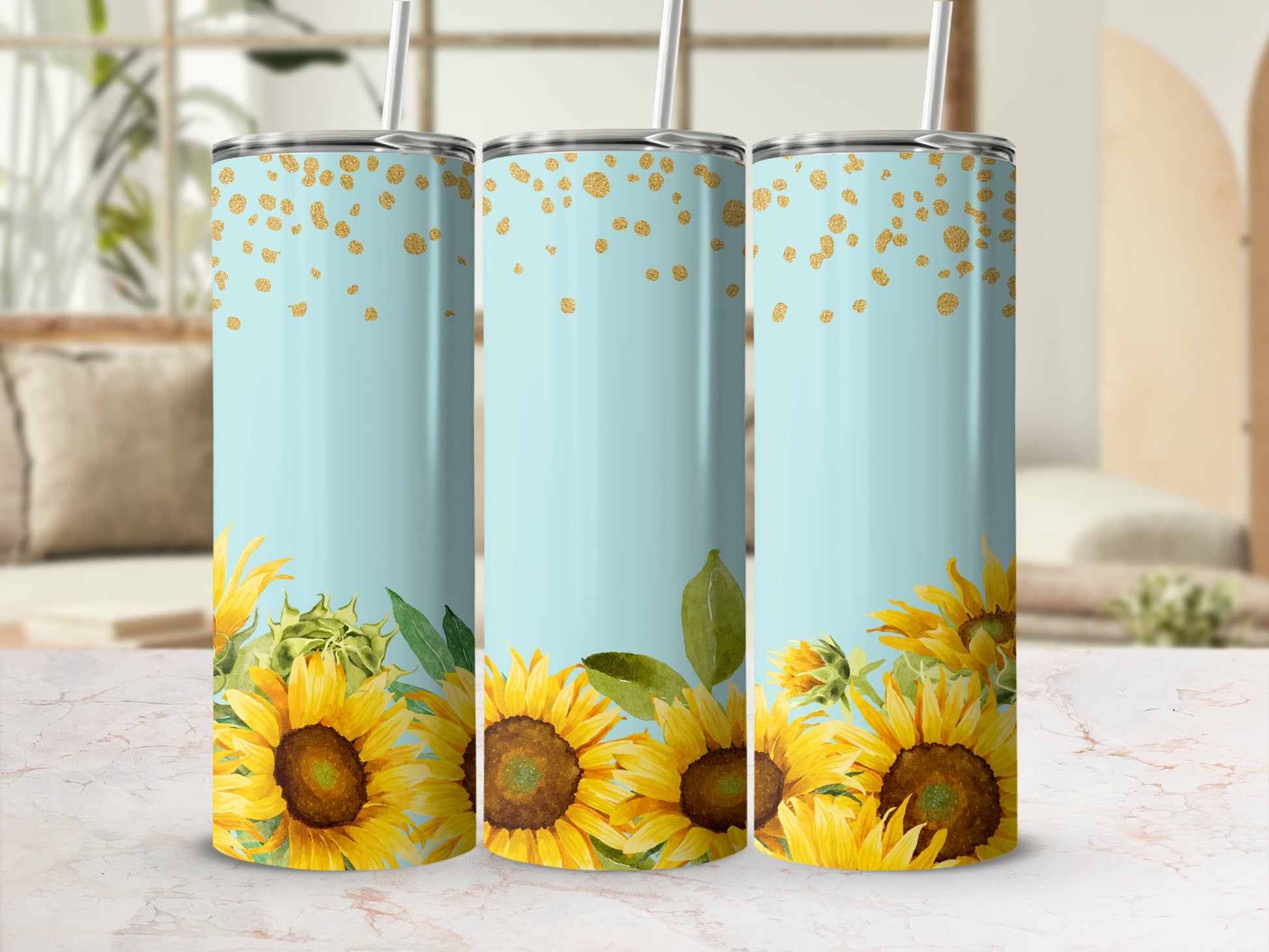 Three light blue tumblers adorned with sunflowers and gold glitter accents.
