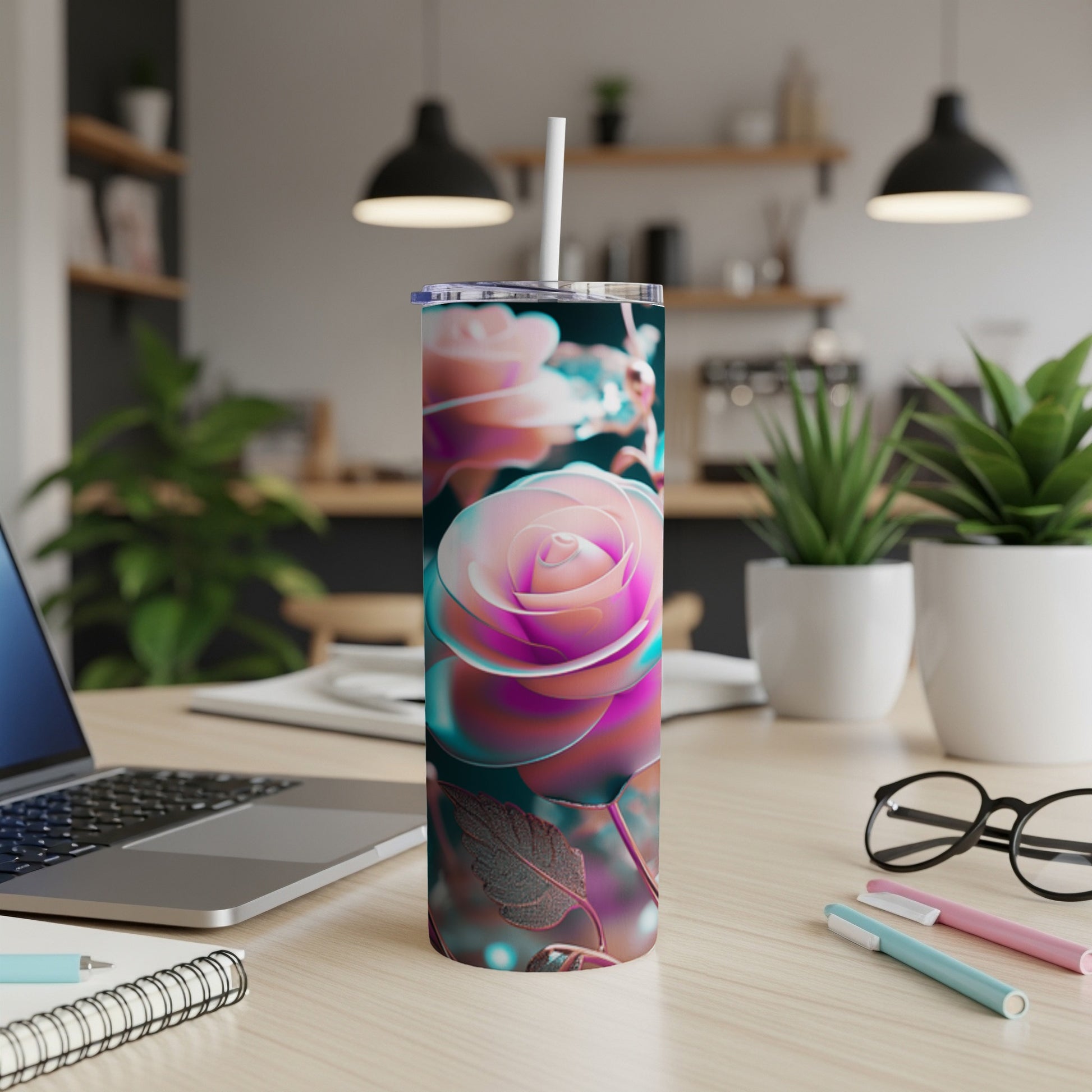 Tumbler with iridescent rose design, sitting on a desk with a laptop.