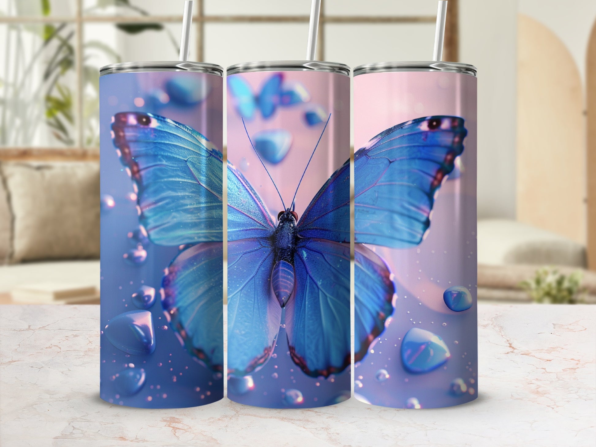 Blue butterfly design on three tumblers with water droplets.