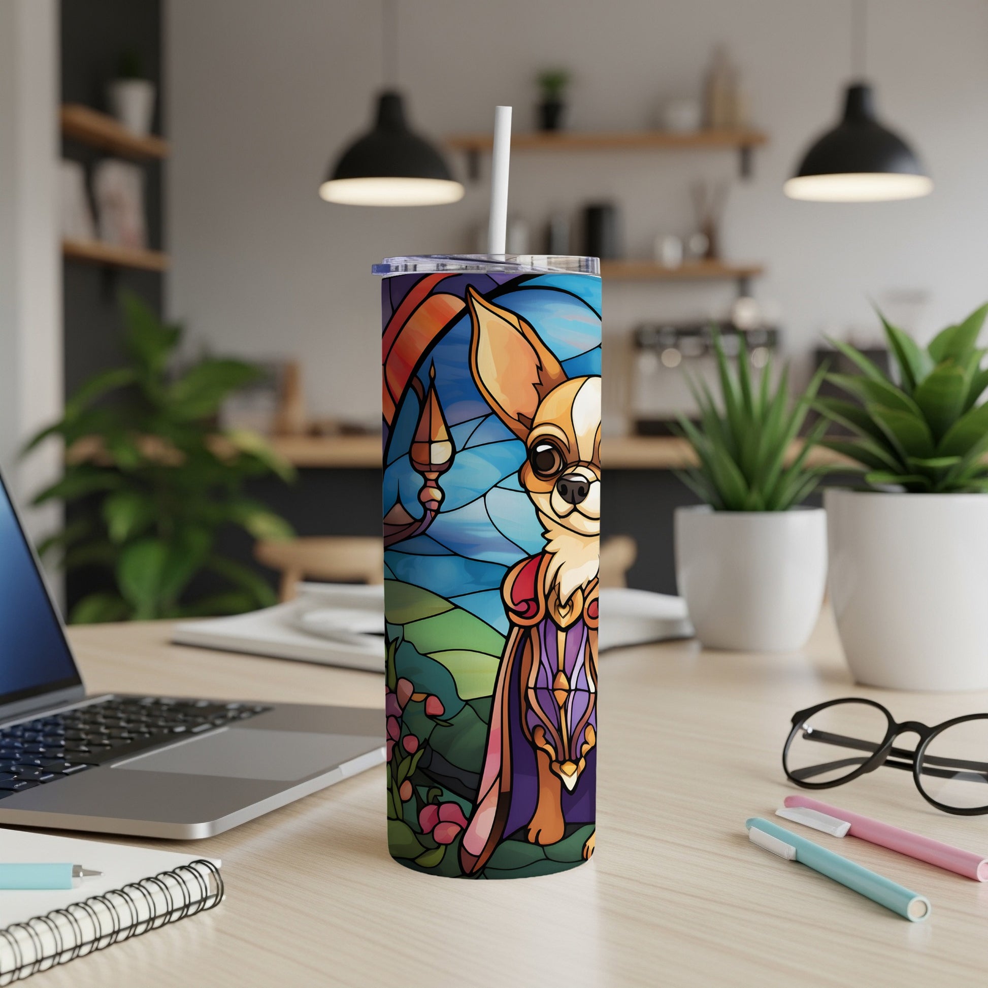 Tumbler with stained glass chihuahua and floral design, on a desk.