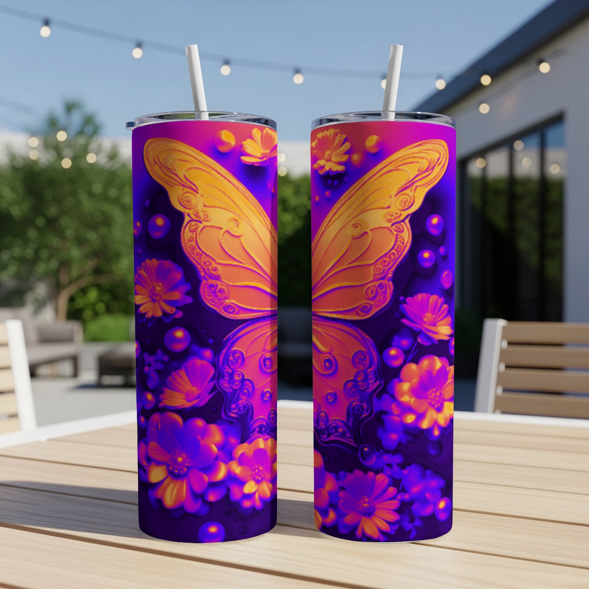 Two purple tumblers with orange butterfly and floral designs on a table.
