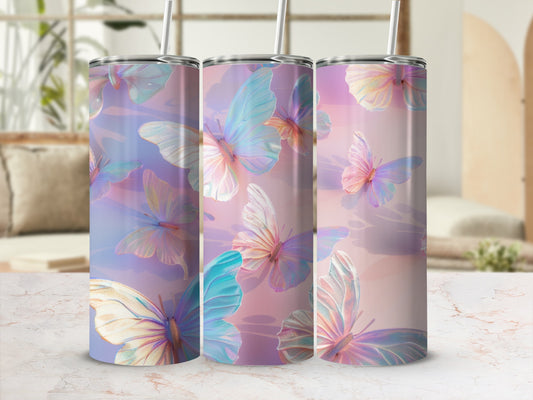 Three tumblers with iridescent butterfly designs on a marble surface.