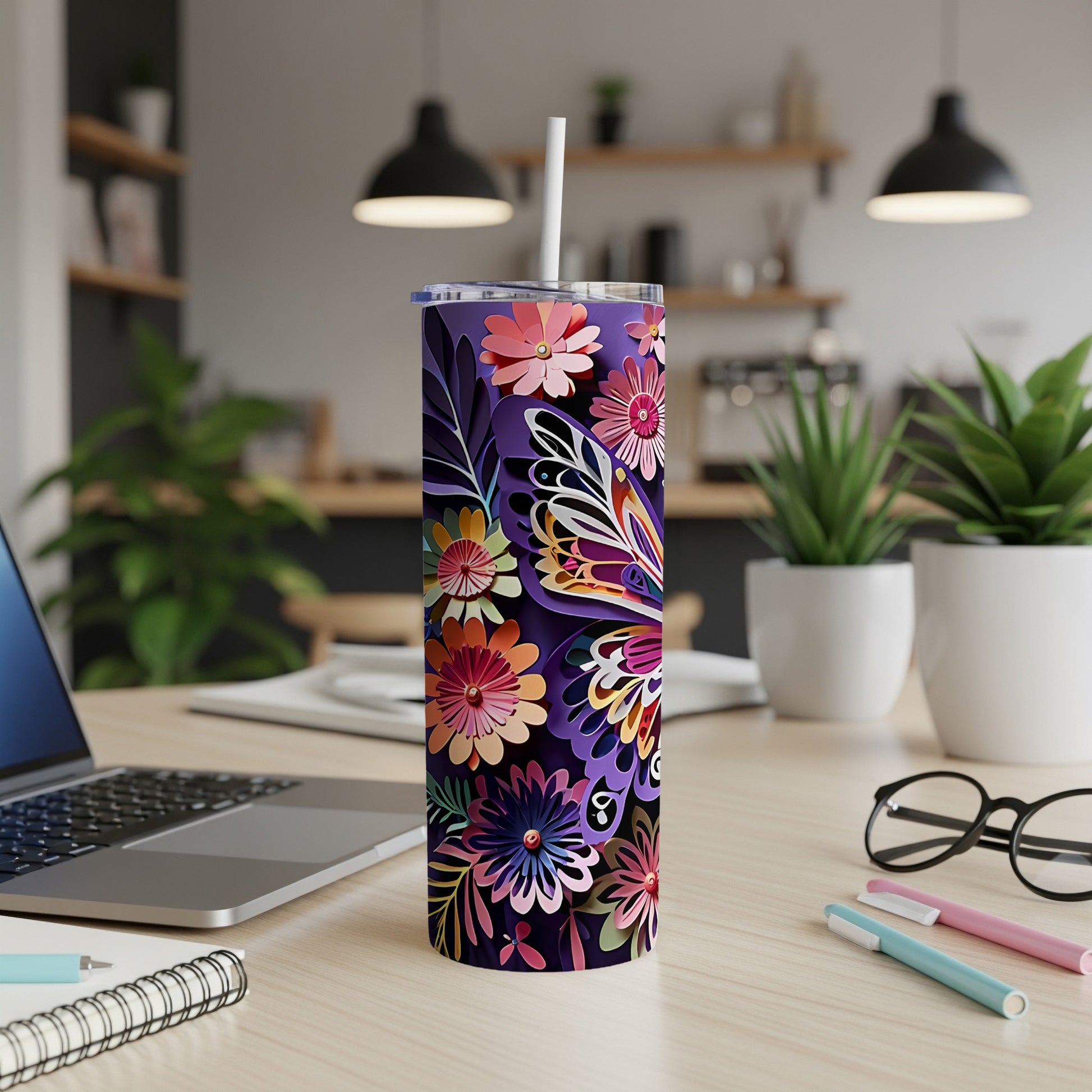Purple tumbler with colorful floral and butterfly design, straw inserted.