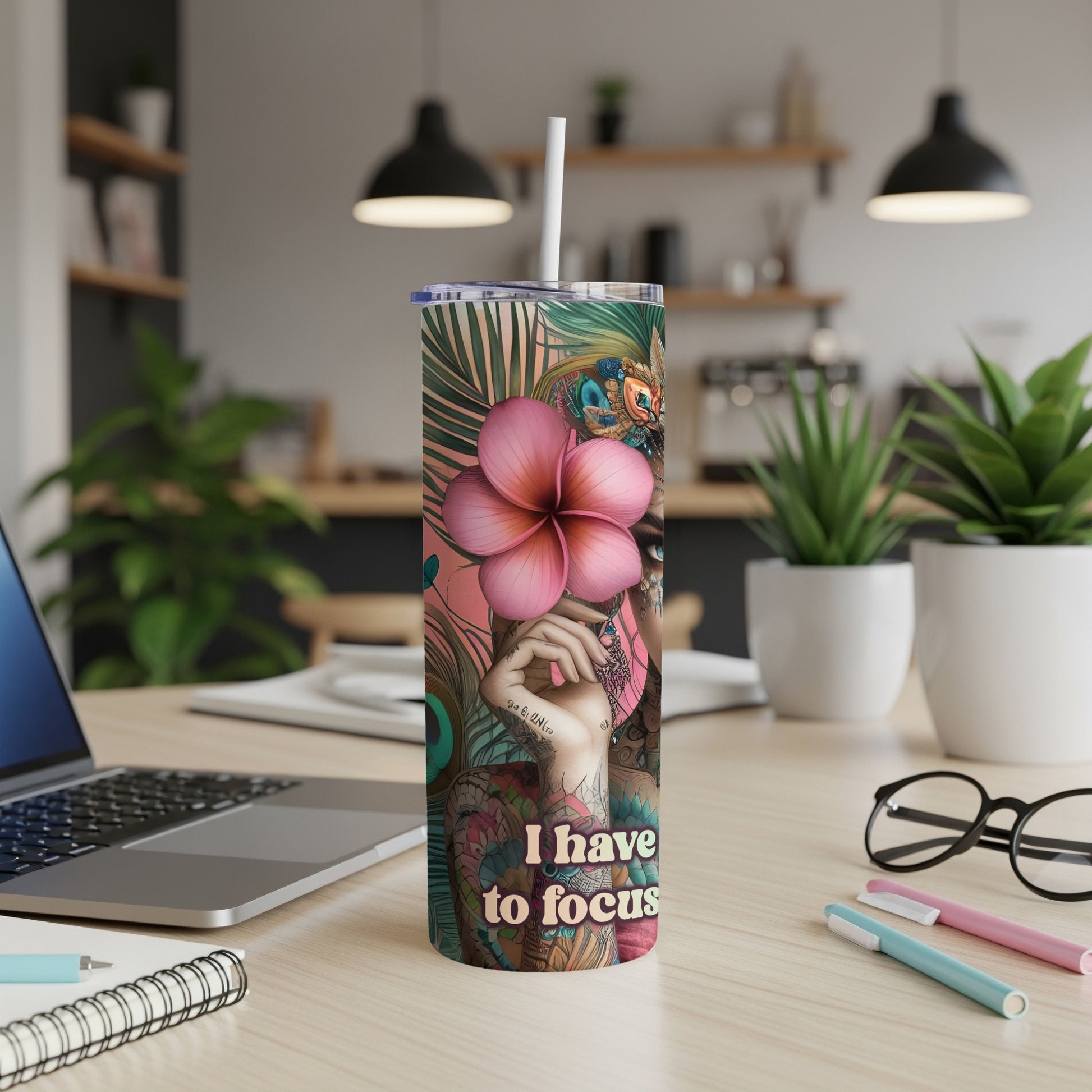 Pink and teal floral pattern tumbler with "I have to focus" text.