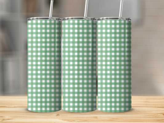 Three green and white gingham pattern tumblers with straws.