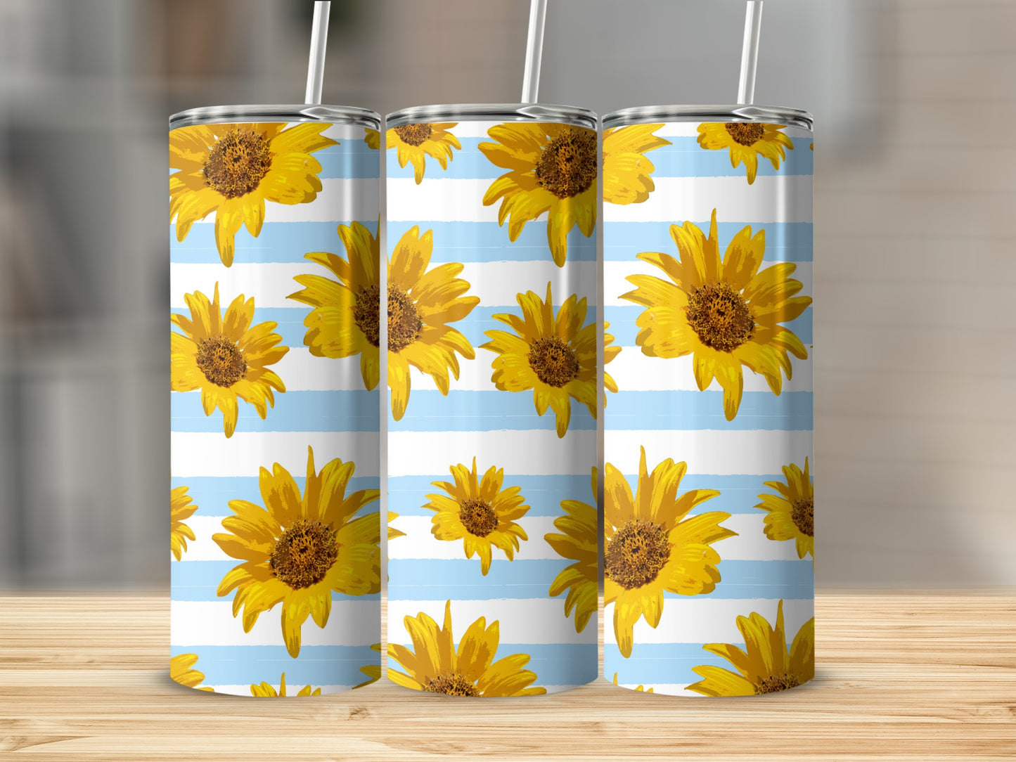 Three tumblers with a sunflower pattern on blue and white stripes.