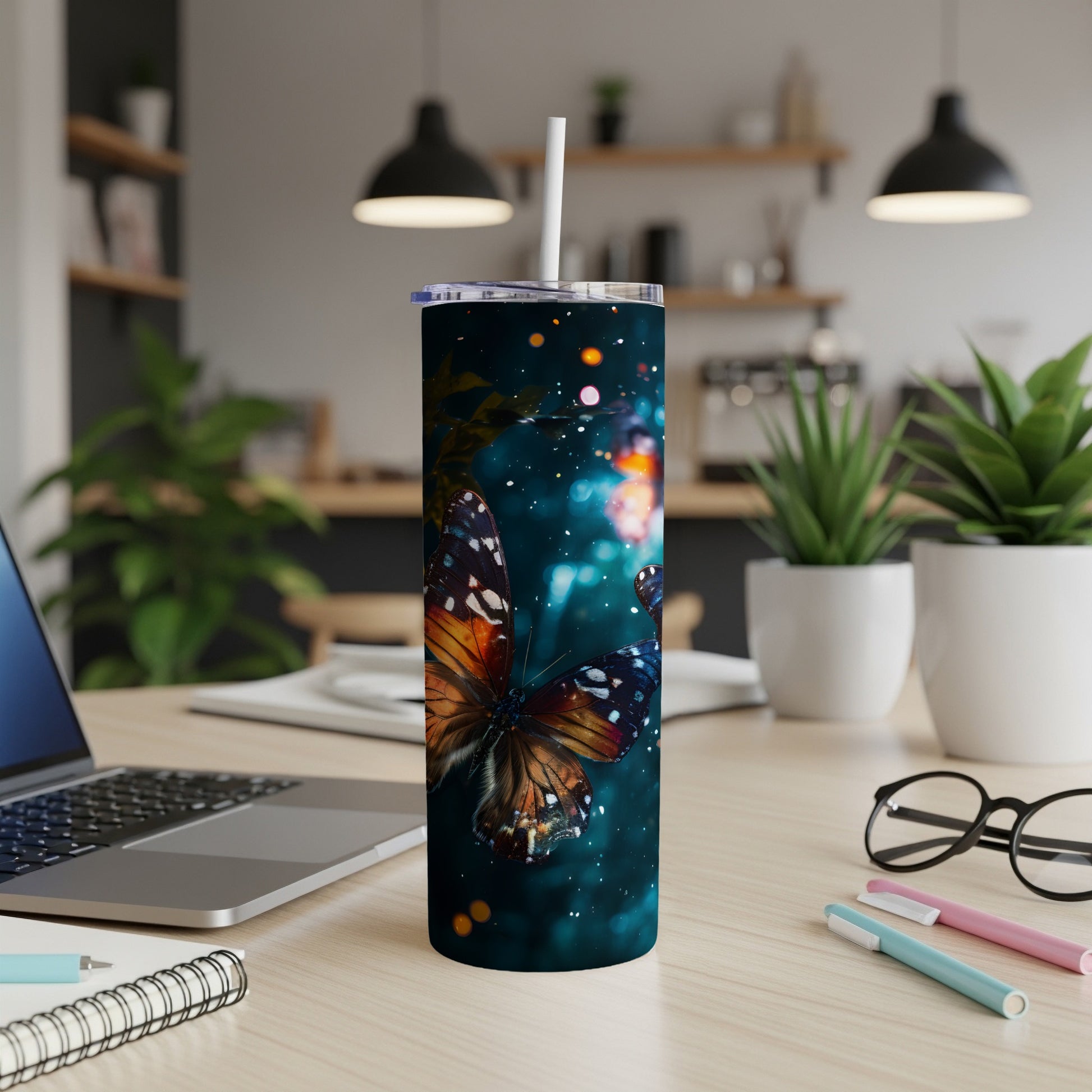 Tall tumbler with a dark background and orange and blue butterfly design.