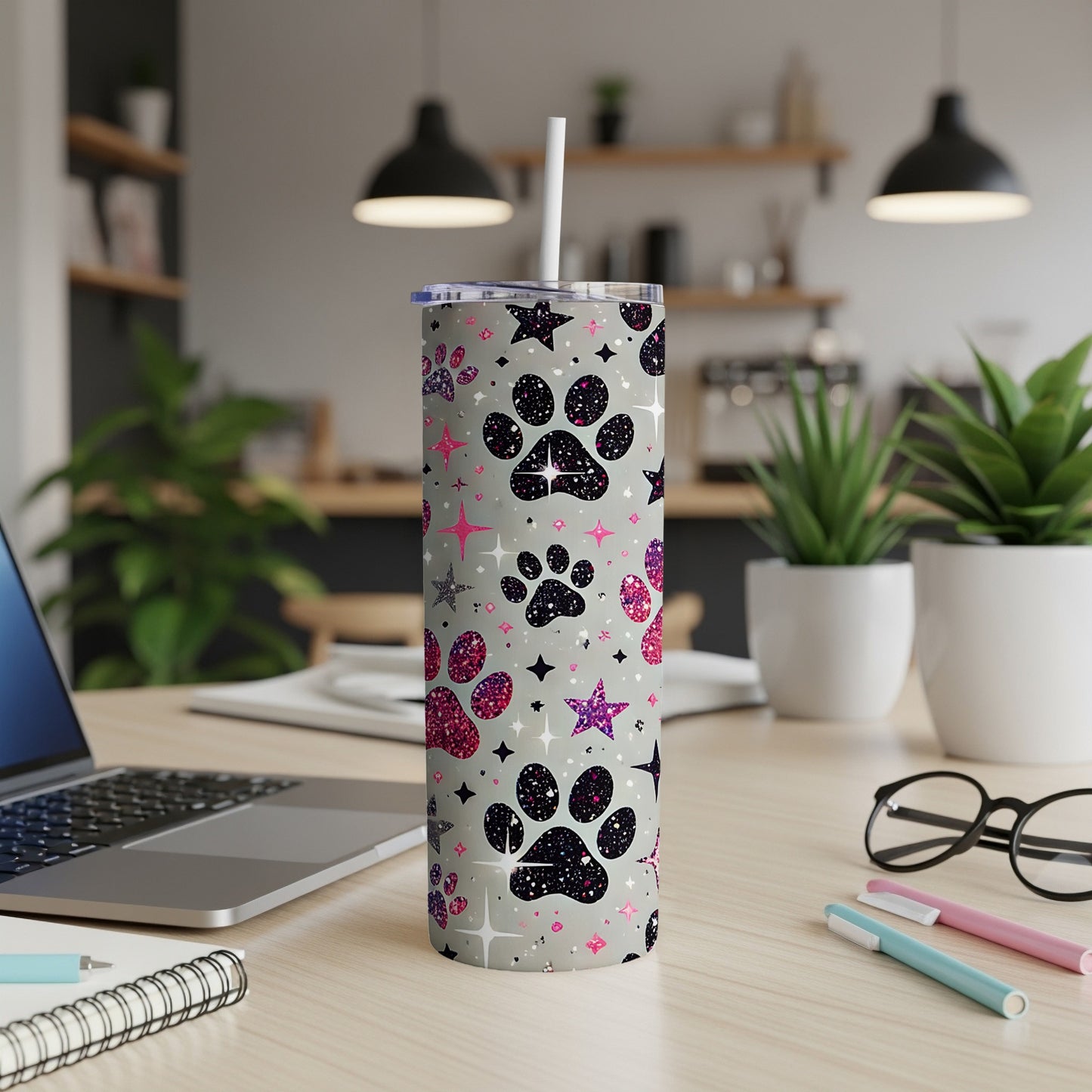 Gray tumbler with black, pink, and silver paw prints and stars.