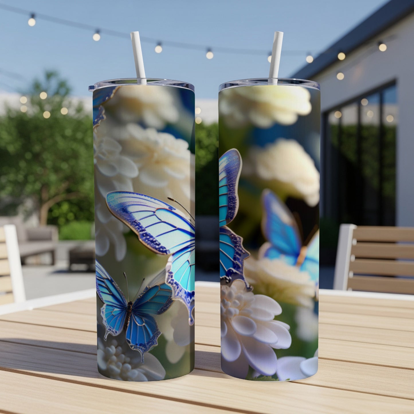 Two blue butterflies on white flowers adorn clear tumblers with straws.