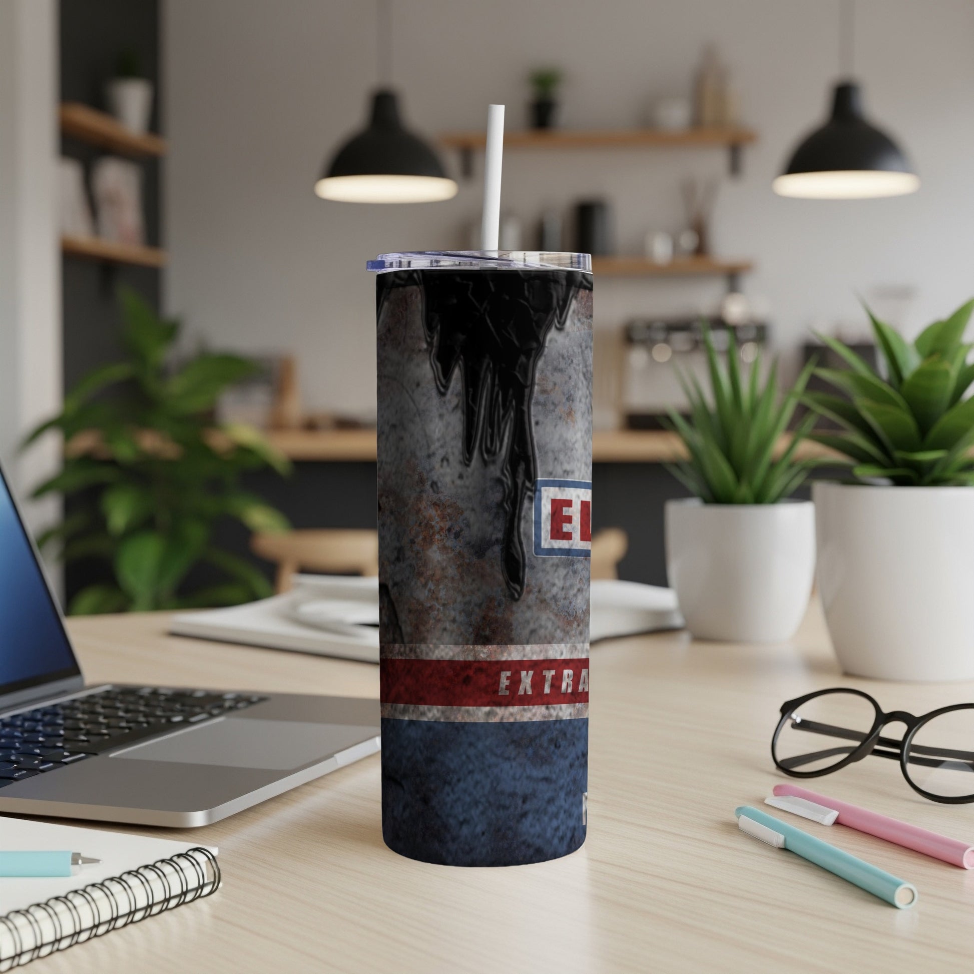 Tapered tumbler with black oil, rust, and red/blue stripe design, "EXTRA" text.