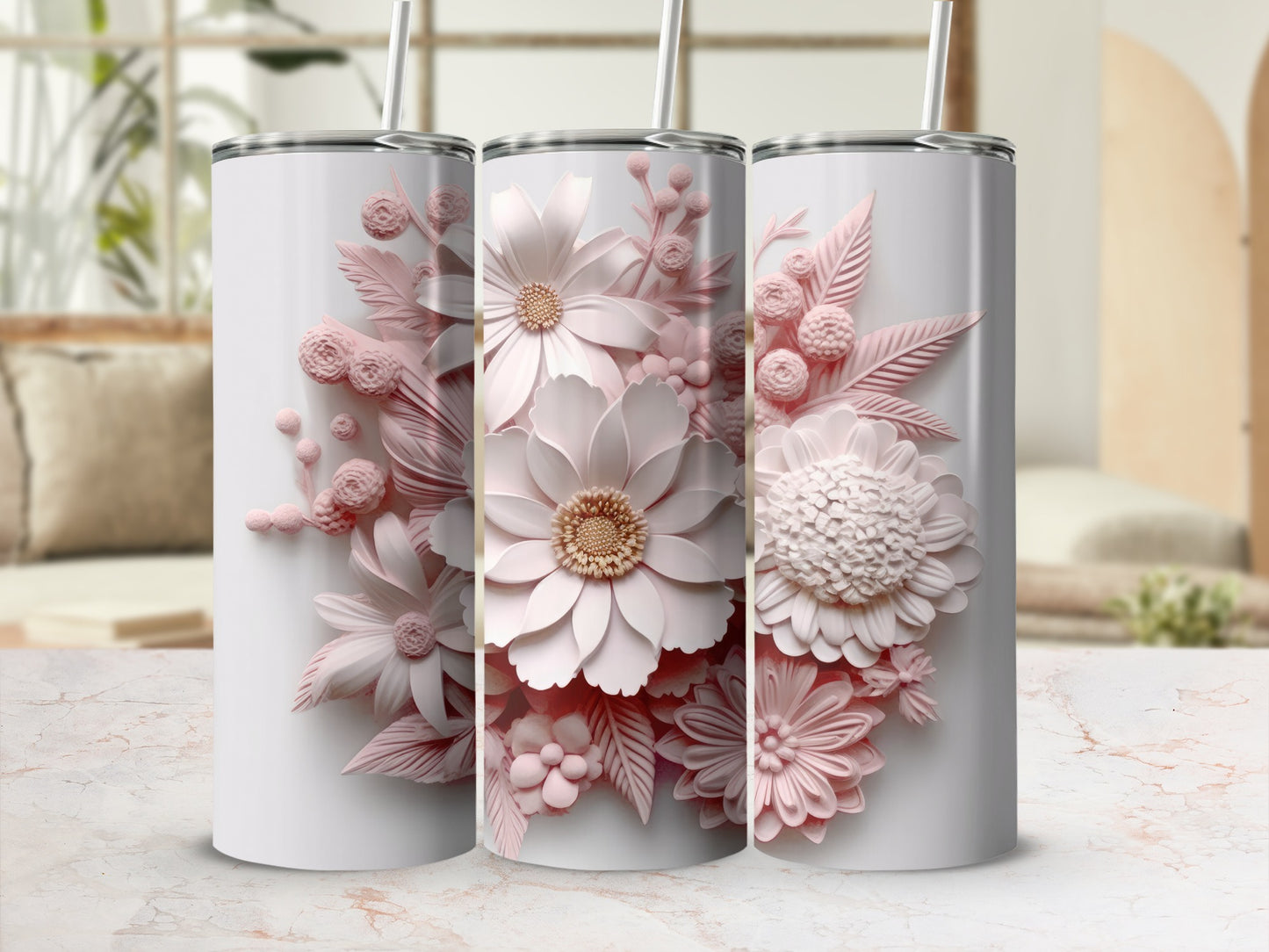 Three white tumblers with raised pink floral designs displayed on a marble surface.
