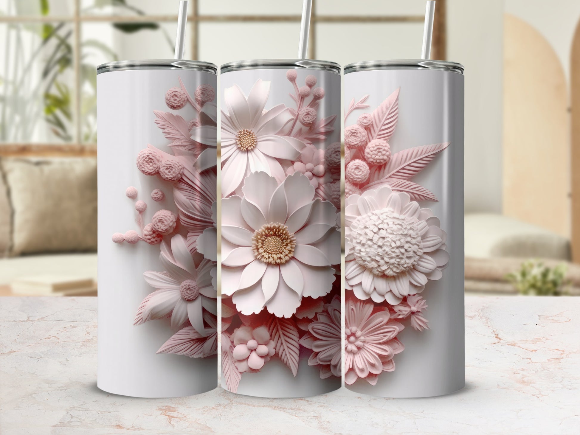 Three white tumblers with raised pink floral designs displayed on a marble surface.