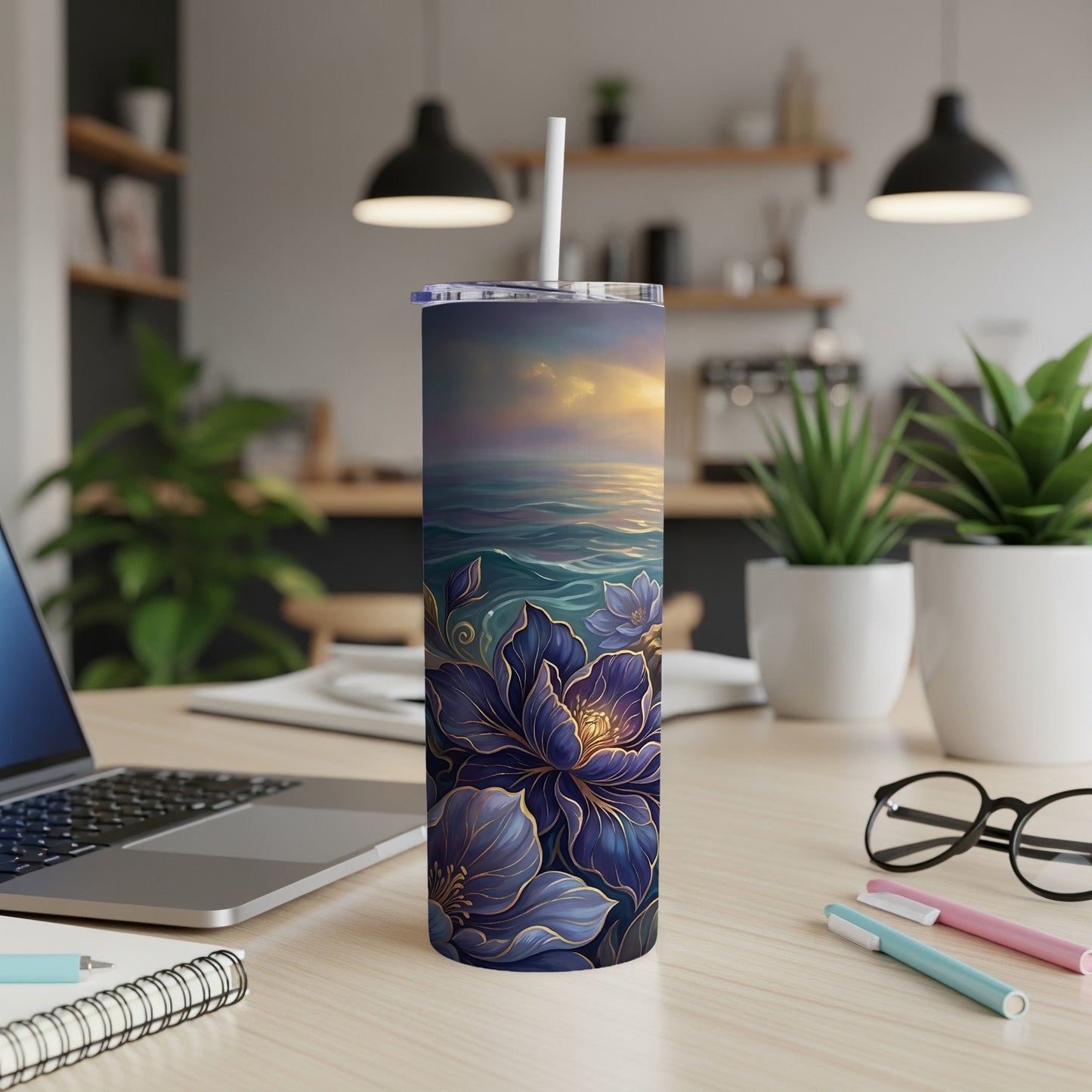 Tumbler with a sunset over water and floral design.