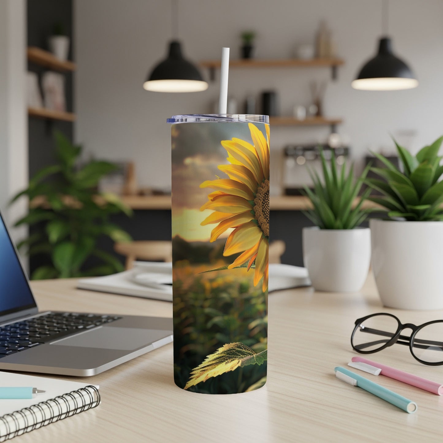 Sunflower on a tumbler with a desk and laptop background.