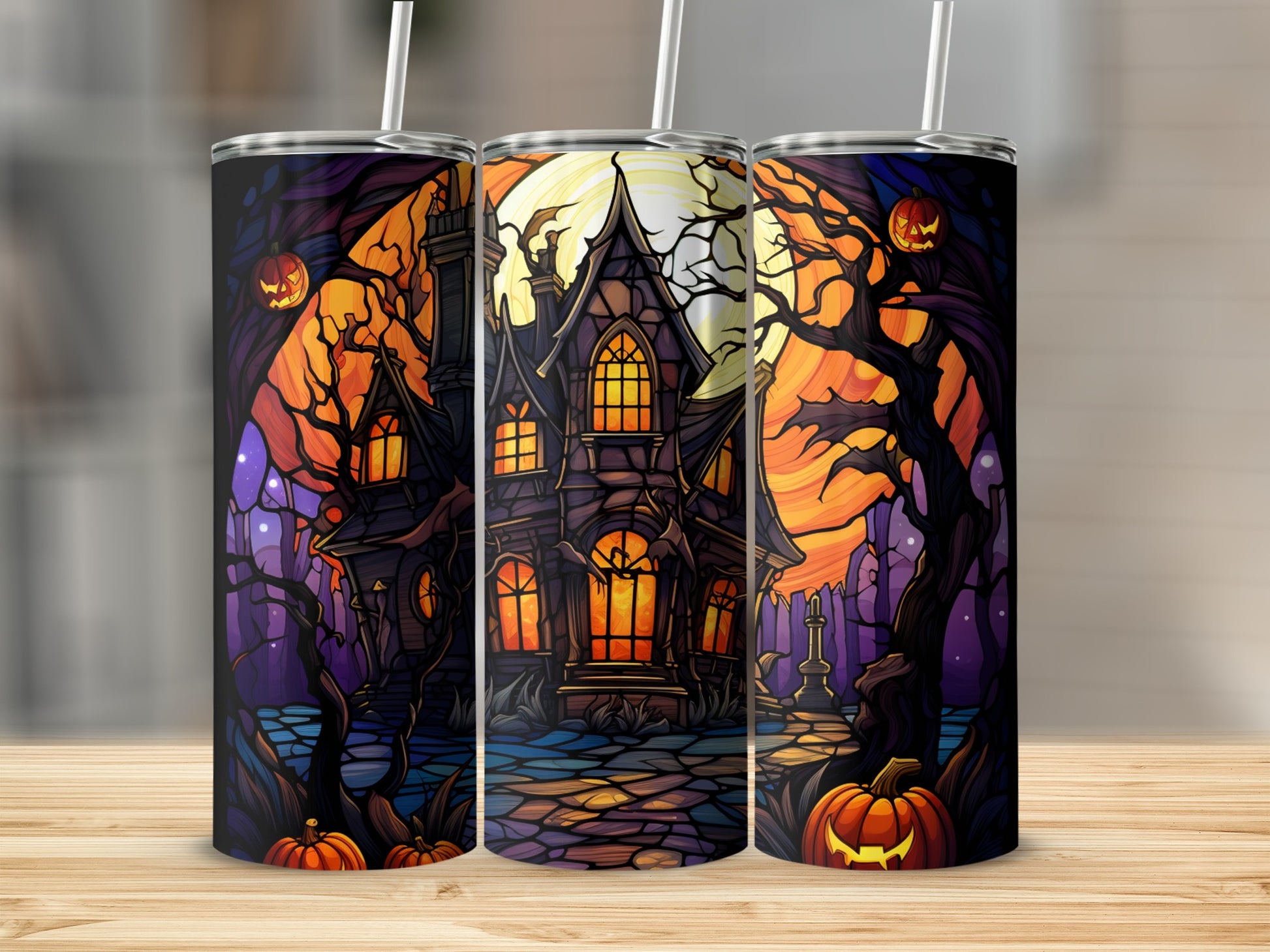 Three Halloween-themed tumblers featuring a spooky house, pumpkins, and trees.