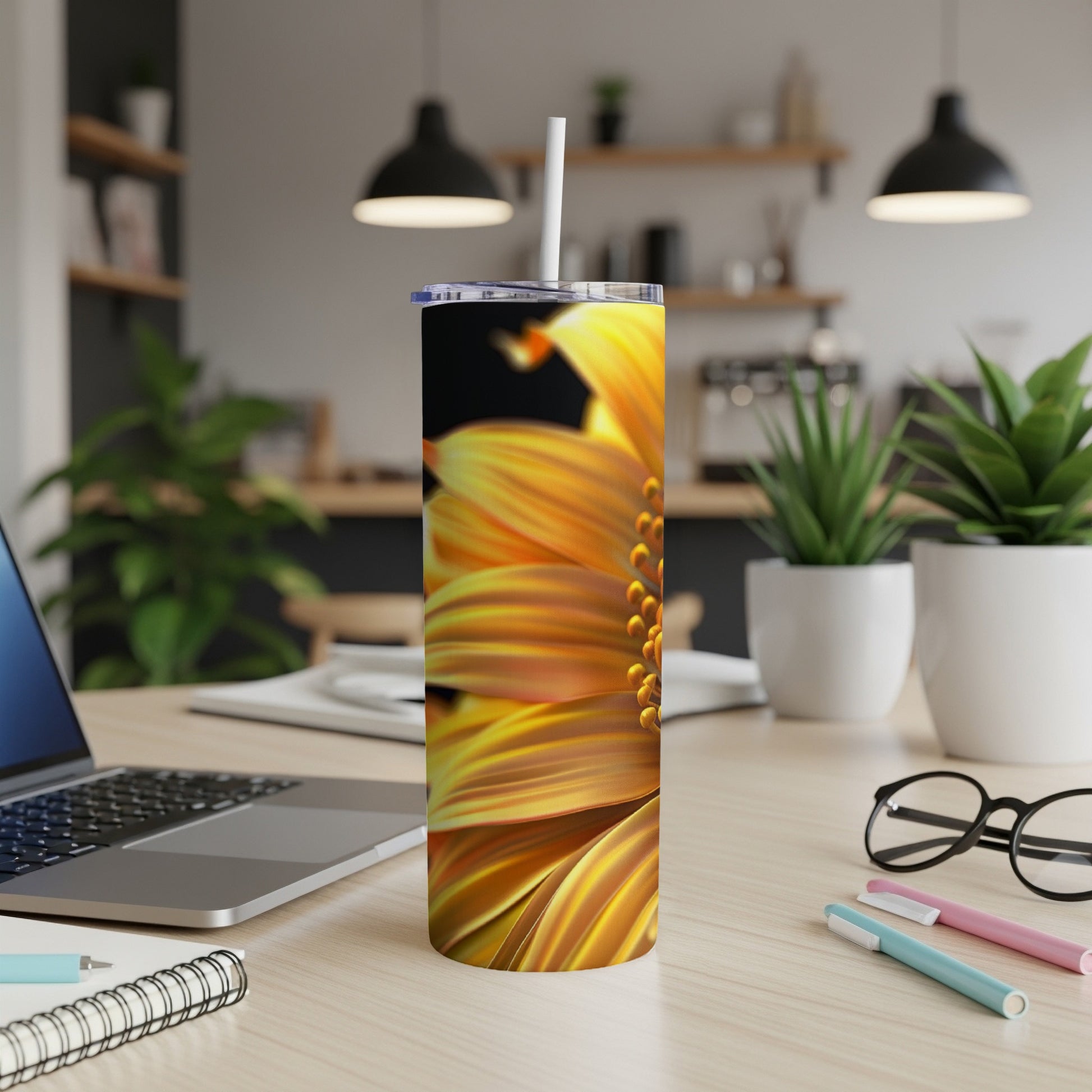 Close-up of a yellow and orange sunflower on a stainless steel tumbler.